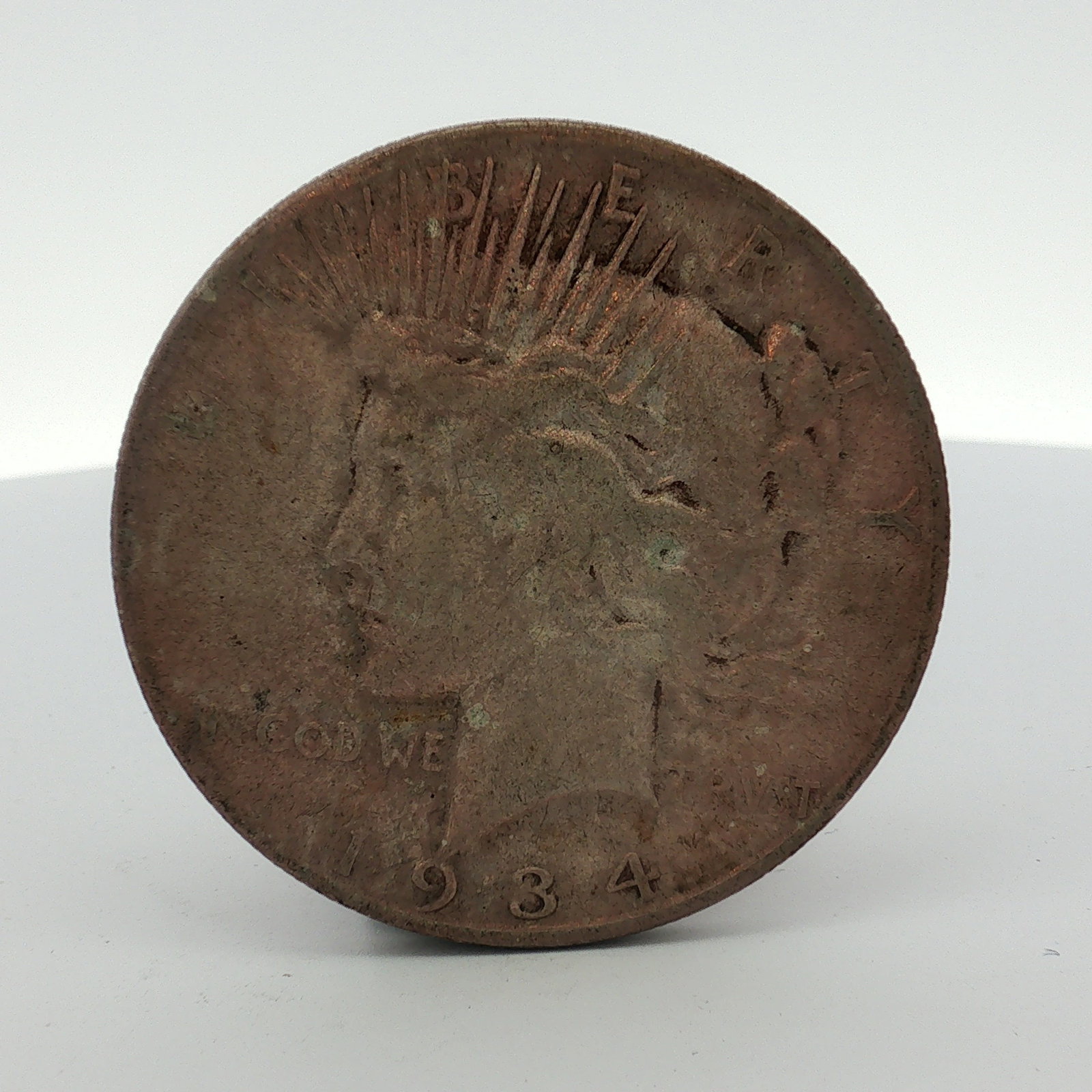 1934-S US Peace Silver Dollar: This United States Peace silver dollar is dated 1934 and is struck in 90 percent silver. The obverse features the Liberty design with inscriptions for LIBERTY and IN GOD WE TRVST. The reverse depicts 