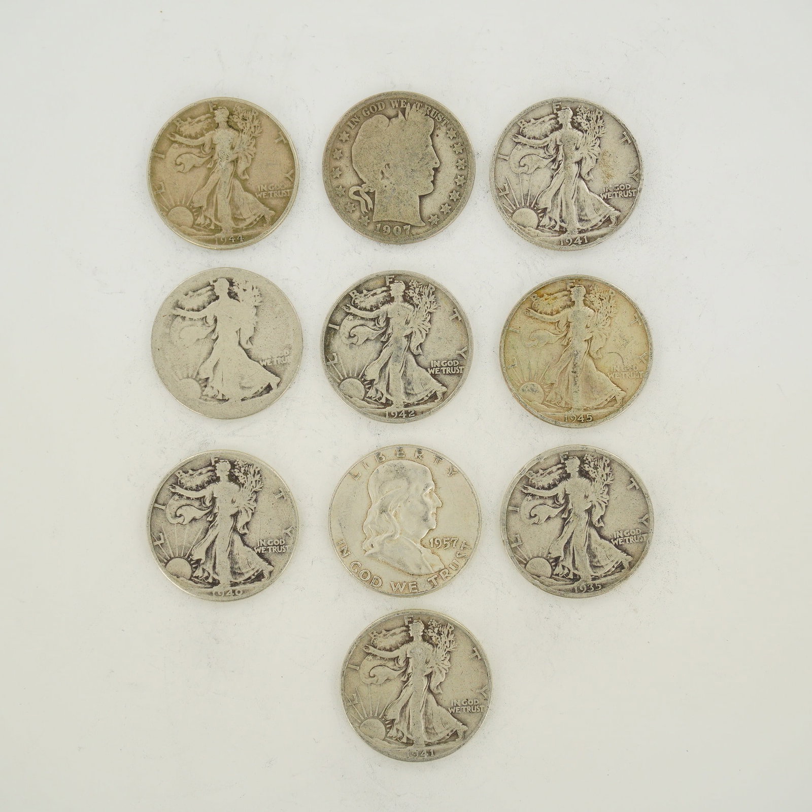 A Collection of US Silver Half Dollars: A collection of Walking Liberty silver half dollars, also including Barber and Franklin types. The group includes Walking Liberty half dollars with dates including 1935, 1940, 1941, 1942, 1944, and 19