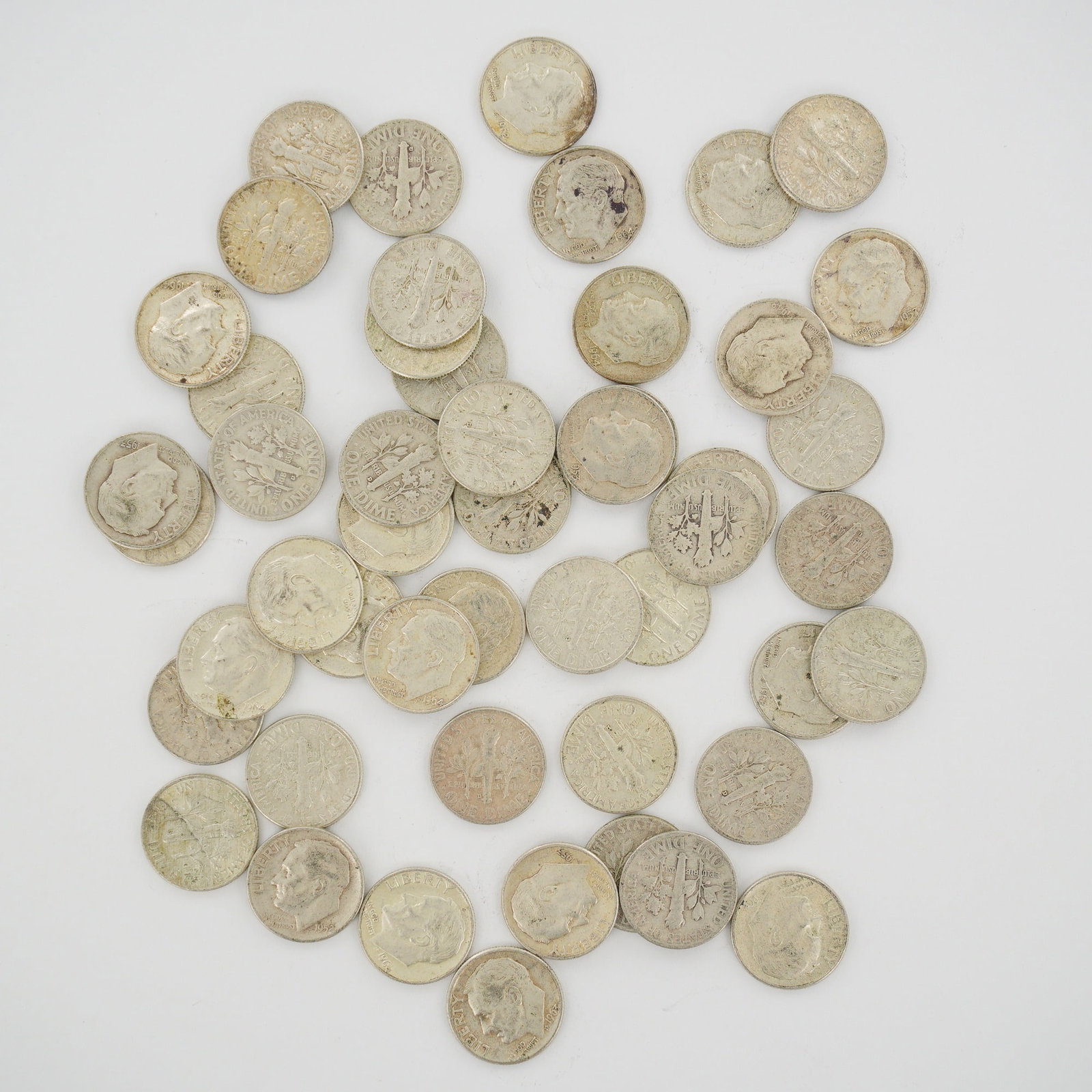 A Mixed Date Bag of U.S. Mint 90% Silver Roosevelt Dimes: A collection of United States Roosevelt silver dimes presented as a mixed date bag of coins struck in 90% silver. This assortment primarily dates from the mid-20th century prior to 1965, with visible 