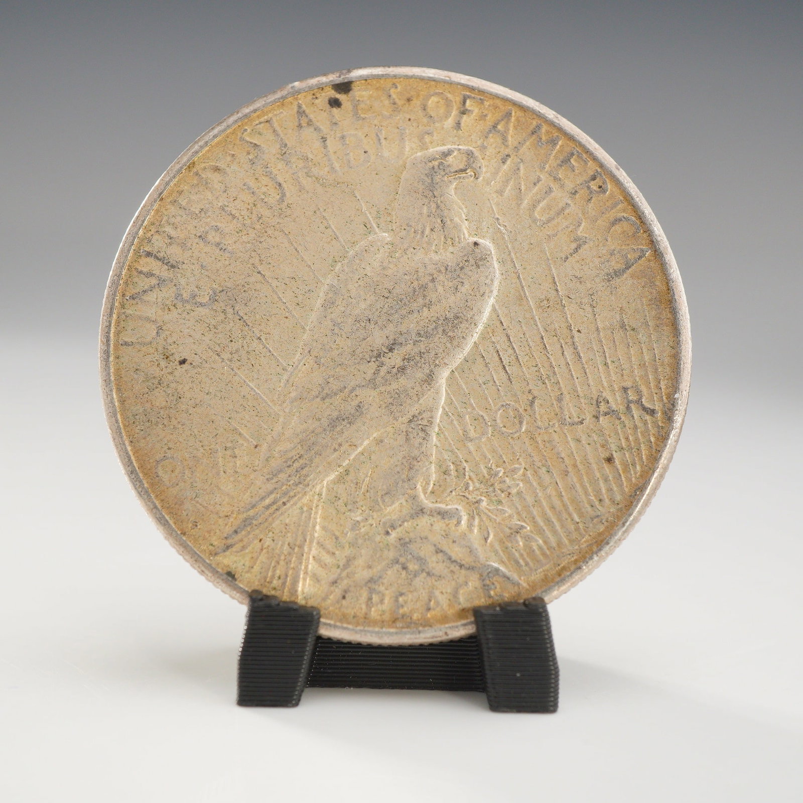 1923-S US One Dollar Peace Silver Dollar Coin, Circulated: This 1923 Peace silver dollar was produced at the San Francisco Mint, as indicated by the absence of a mint mark on the reverse. The coin is struck in 90% silver and 10% copper. The obverse features t