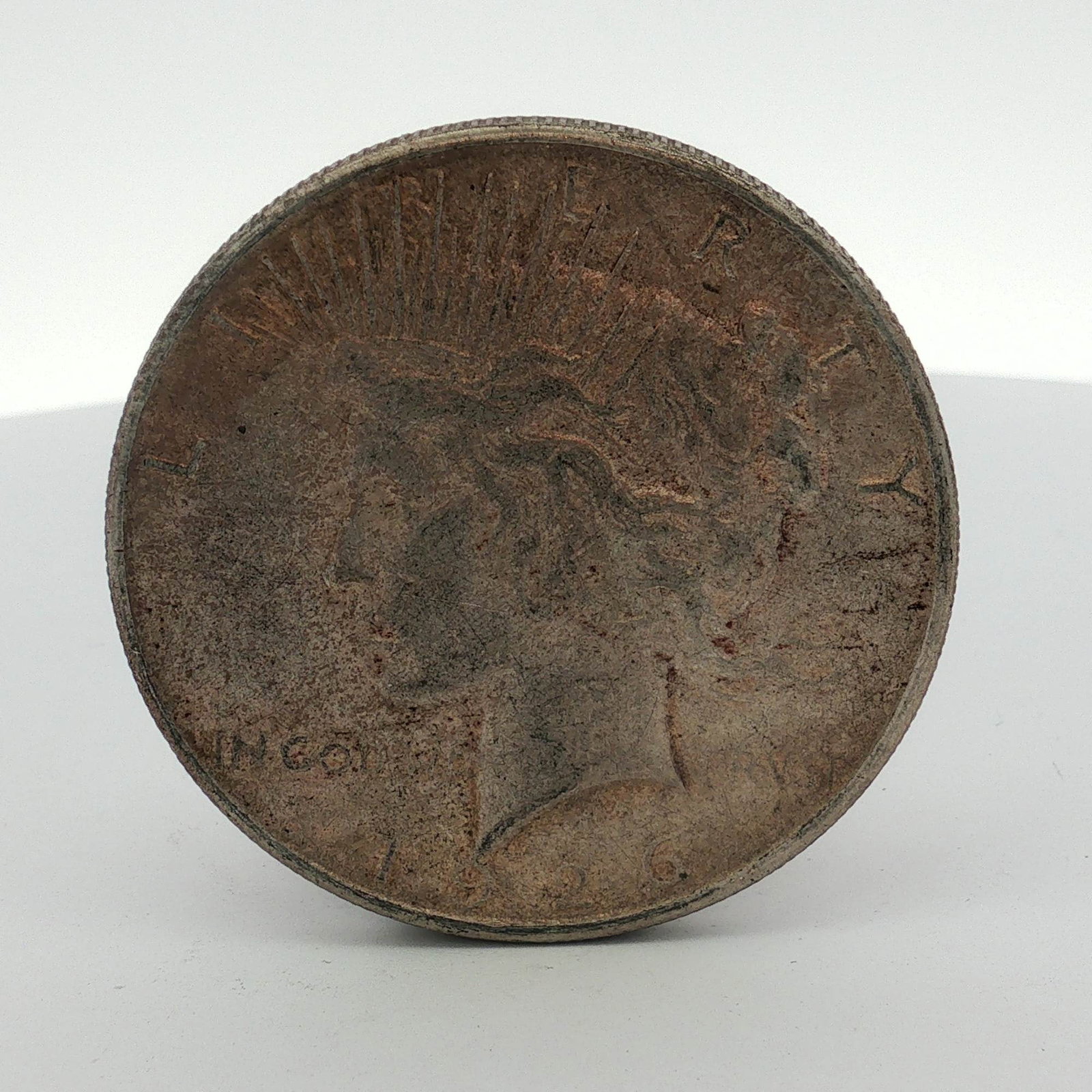 1926-S US One Dollar Peace Silver Dollar Coin, Circulated: A US 1926 Peace Silver Dollar. This coin is composed of 90% silver and 10% copper. The specimen features the Peace dollar design on obverse and reverse. The S mint mark on the reverse indicates the