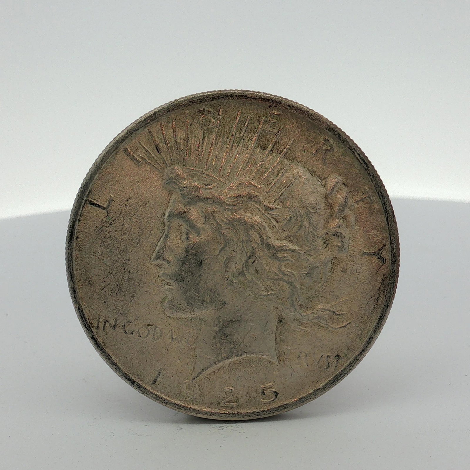 US 1923 Peace Silver Dollar: US 1923 Peace silver dollar. This struck coin is composed of 90 percent silver and 10 percent copper. The obverse and reverse utilize the standard design type for the series. The absence of a mint mar