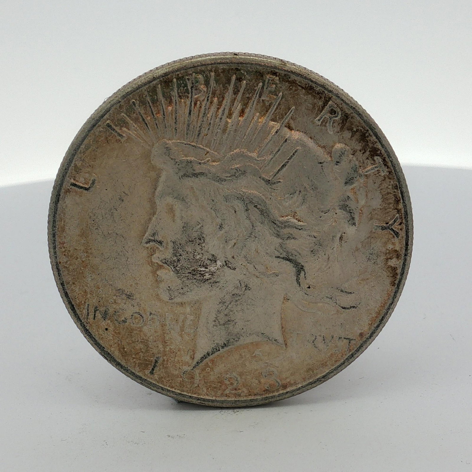 US 1923 Silver Peace Dollar: This US 1923 Peace Dollar is struck in 0.900 fine silver. The obverse features the Liberty design with a radiant crown, bearing the date 1923 and the inscriptions LIBERTY and IN GOD WE TRVST. The