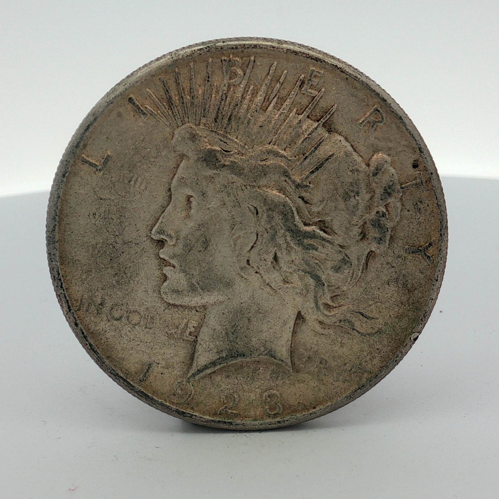 US 1923-S Peace Silver Dollar: This United States 1923-S Peace silver dollar was struck at the San Francisco Mint, as indicated by the small S mint mark located on the reverse. The coin is composed of 90% silver and 10% copper. The