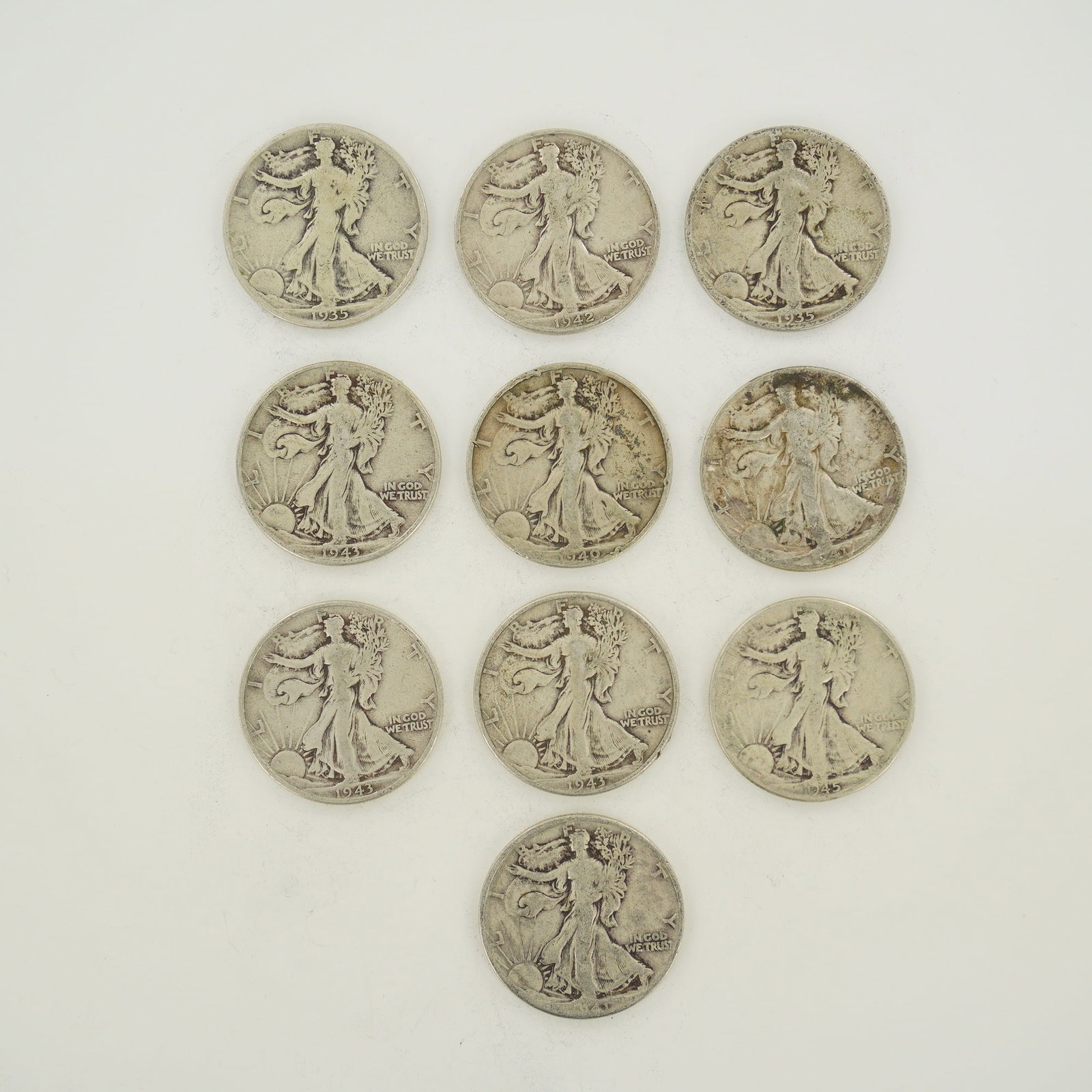 A Collection of US 90% Silver Walking Liberty Half Dollars: This collection of US 90% silver Walking Liberty half dollars is presented as a mixed date bag of struck circulated coins. The coins are composed of 90% silver and 10% copper. Visible dates in the gro