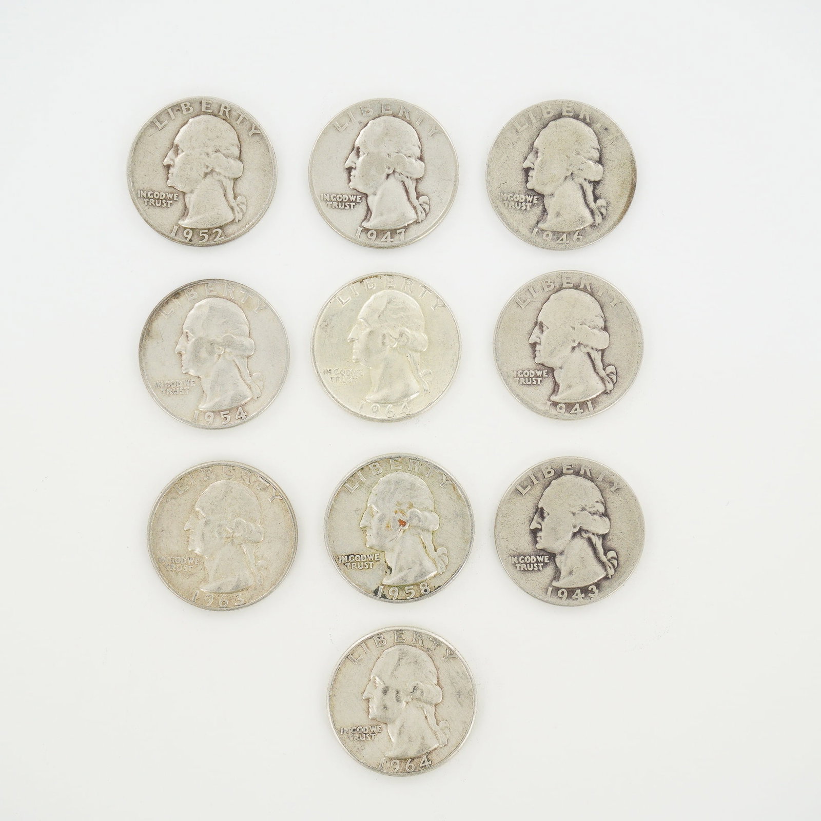 10pc Pre-1964 U.S. 90% Silver Washington Quarters: A collection of ten US Washington Quarter Dollars composed of 90% silver and 10% copper. This mixed date bag of coins includes specimens with dates ranging from 1941 to 1964. The specific dates and
