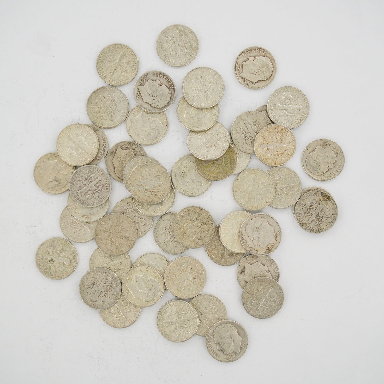 A Collection of US 90% Silver Roosevelt Dimes, Mixed Date Bag: This collection consists of a mixed date bag of US 90% silver Roosevelt dimes. The coins are struck in a composition of 90% silver and 10% copper. Visible dates within the group include 1946, 1948, 19