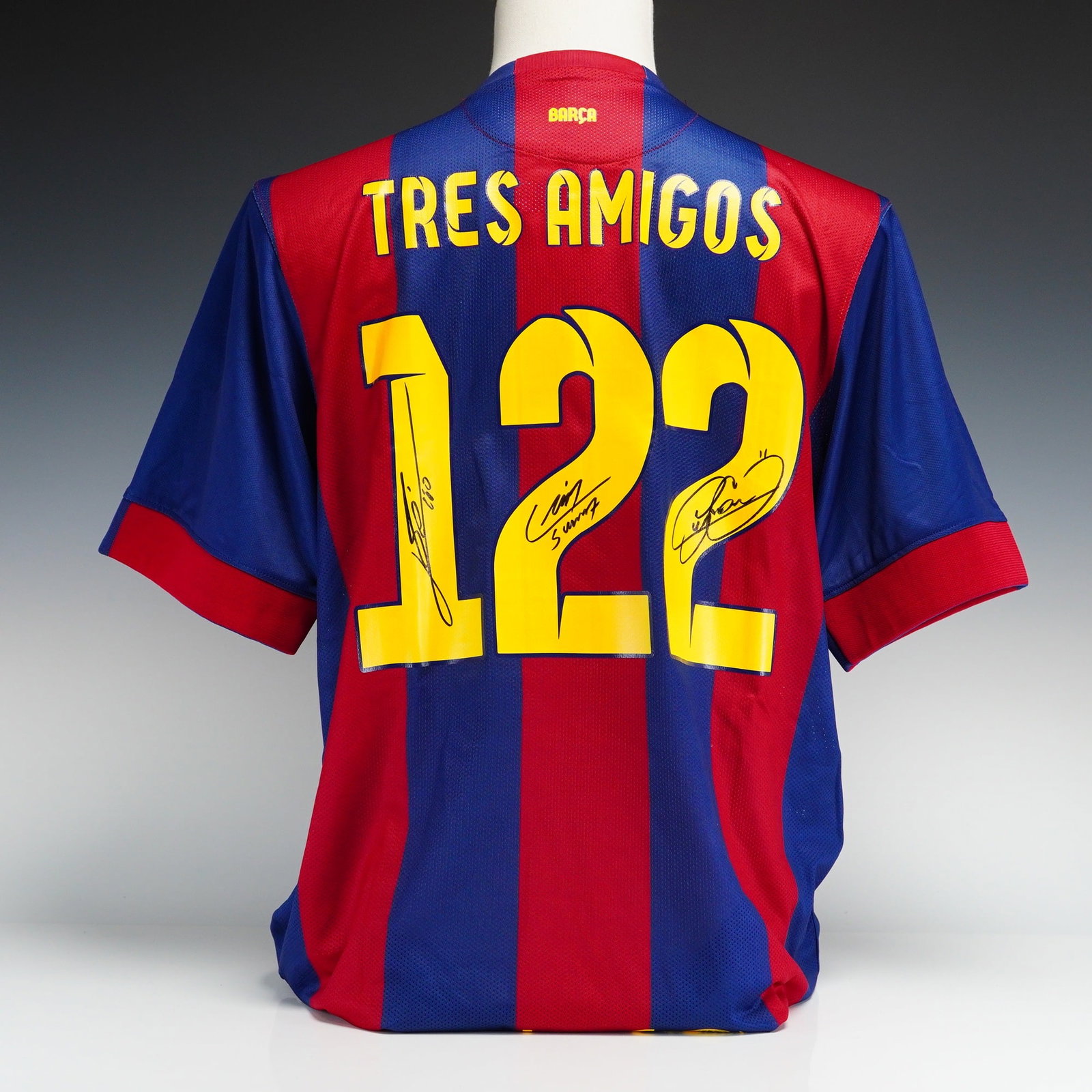 Messi, Suarez, and Neymar Jr. Signed Tres Amigos 2014-15 FC Barcelona Jersey with COA: This lot features an authentic 2014-15 FC Barcelona home jersey manufactured by Nike, specifically commemorating the historic strike partnership of Lionel Messi, Luis Suarez, and Neymar Jr. The