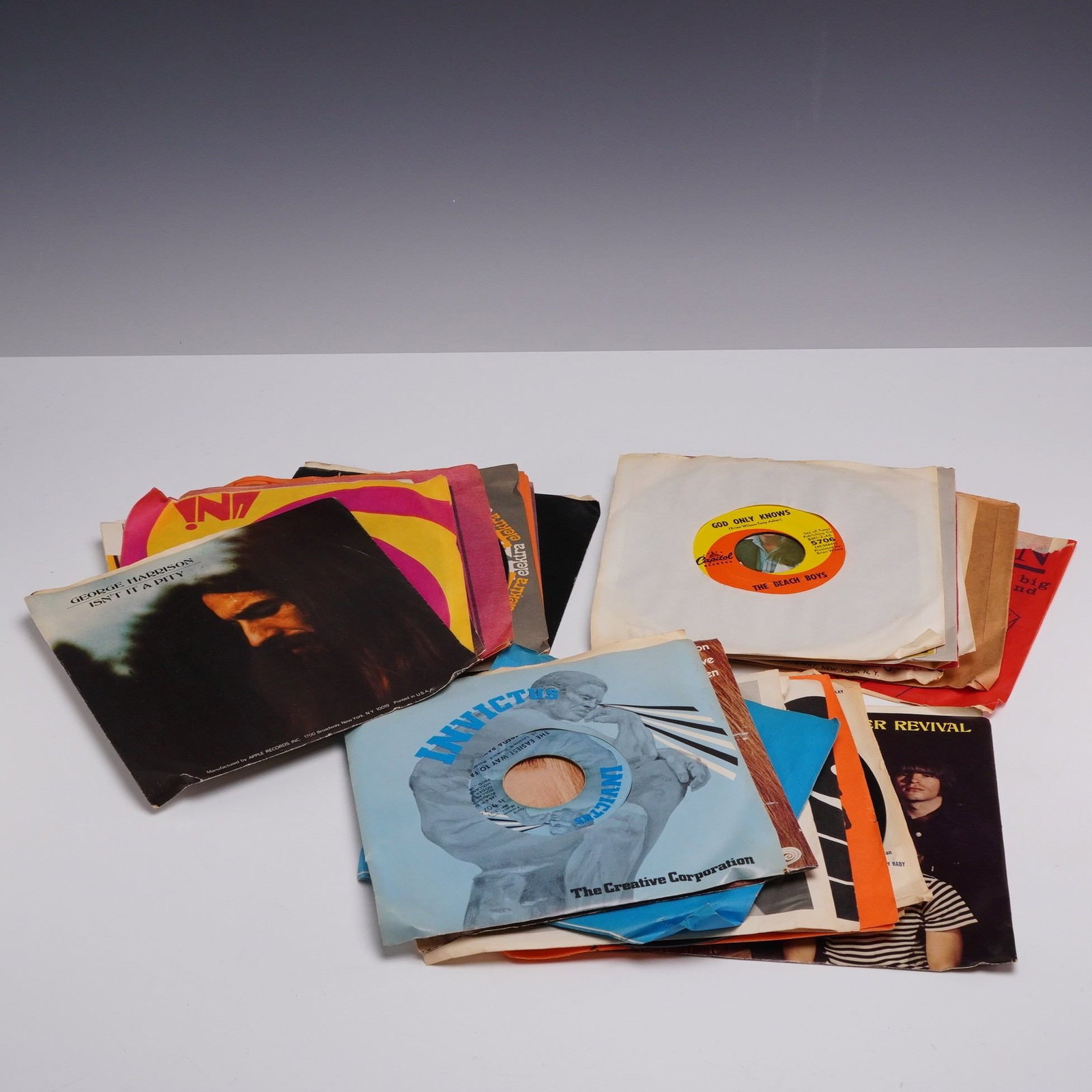 Set of 25 1960-1970s 45 RPM Vinyl Records Including George Harrison, The Beach Boys, and Motown: A set of 25 vintage 7-inch 45 RPM vinyl records dating primarily from the late 1960s and early 1970s. The collection features a variety of rock, pop, and soul artists from major labels of the era. Ide
