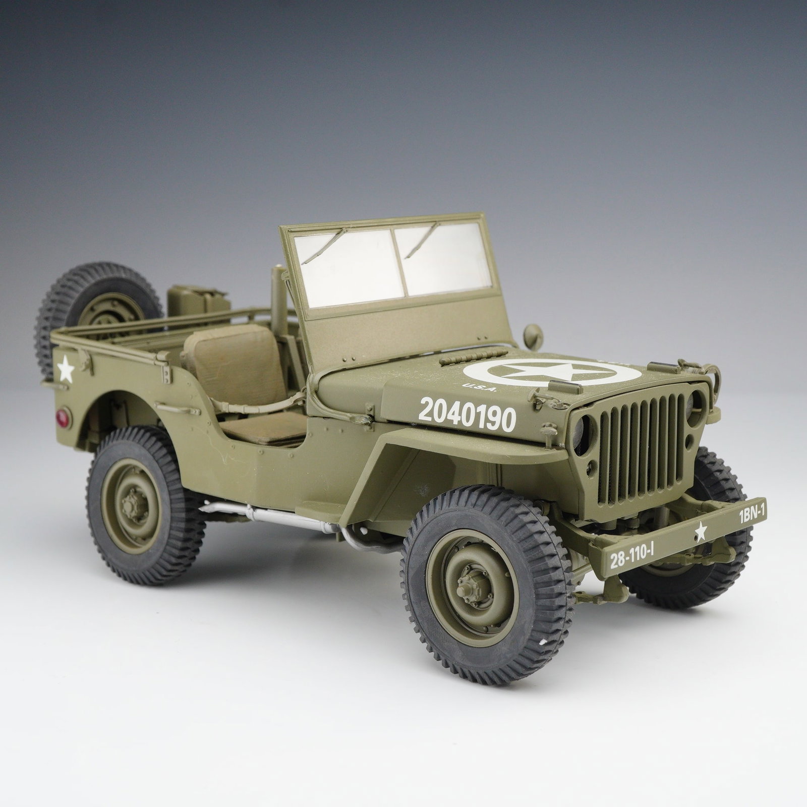 Danbury Mint World War II Jeep Replica: This is a 1:24 scale die-cast replica of a World War II era Jeep produced by The Danbury Mint for the Classic Cars Collection. The model is finished in matte olive drab paint with white United States