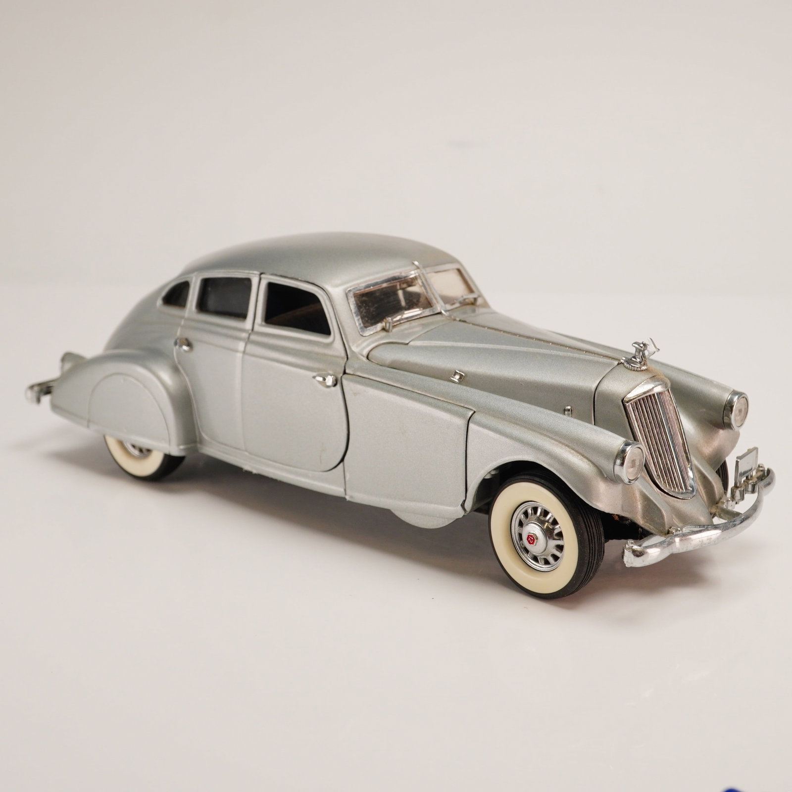 The Danbury Mint Classic Model Car, 1933 Pierce Silver Arrow: This 1:24 scale replica of a 1933 Pierce-Arrow Silver Arrow is part of the Danbury Mint Classic Cars Collection. The model is constructed from die-cast metal with plastic and rubber components. It