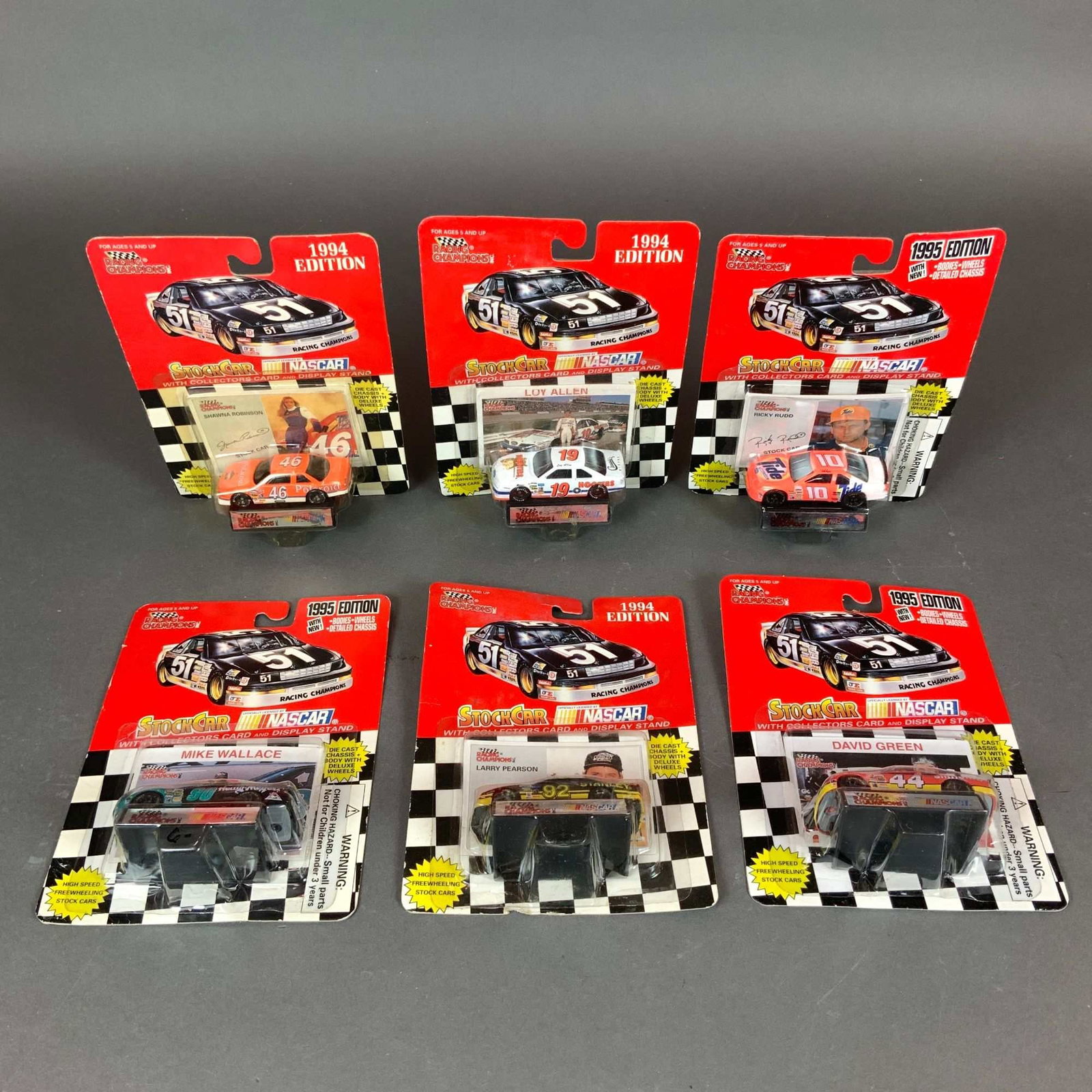 A Lot of Six Racing Champions NASCAR Die-Cast Stock Car Models: This lot consists of six vintage Racing Champions NASCAR 1:64 scale die-cast stock cars in their original factory blister pack packaging. The group includes three models from the 1994 edition and