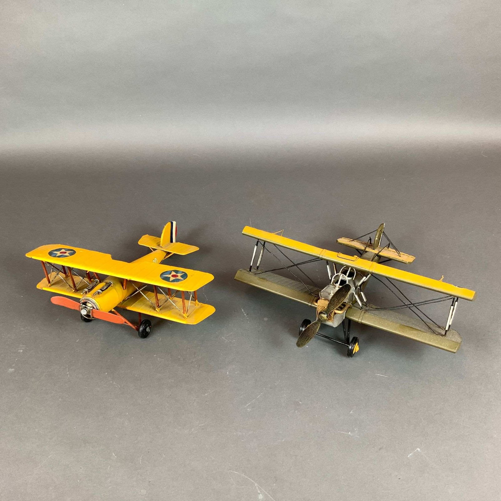 2pc Metal United States Airforce Biplane Model Aircrafts: This lot features a pair of metal aircraft models styled after vintage United States Airforce biplanes, specifically representing interwar era trainers like the Curtiss Jenny and Boeing Stearman. The
