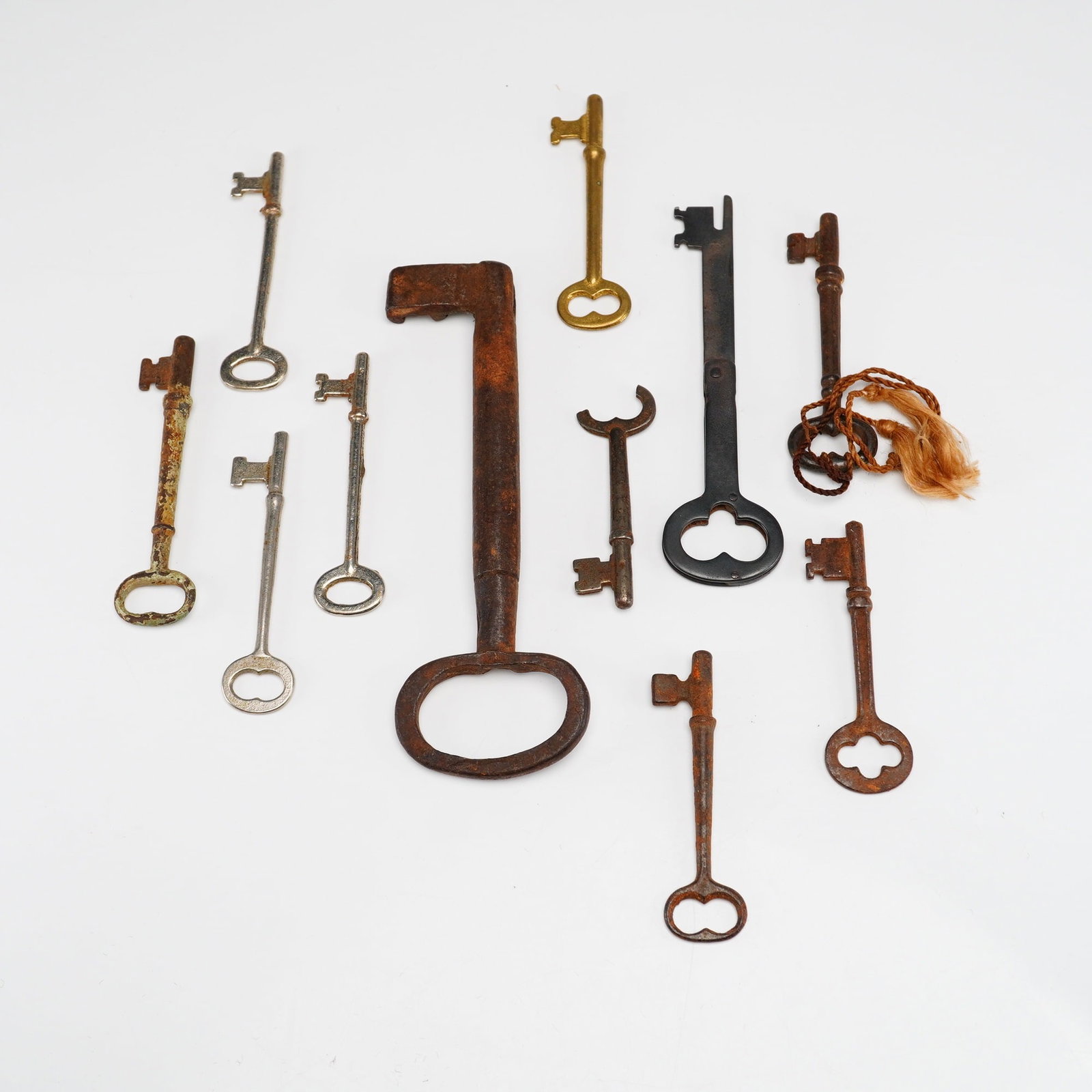 11pc Antique and Vintage Skeleton Bit and Barrel Keys: This assortment contains eleven antique and vintage keys in skeleton, bit, and barrel styles. The materials represented include wrought iron, cast iron, brass-toned metal, and nickel-plated or polishe