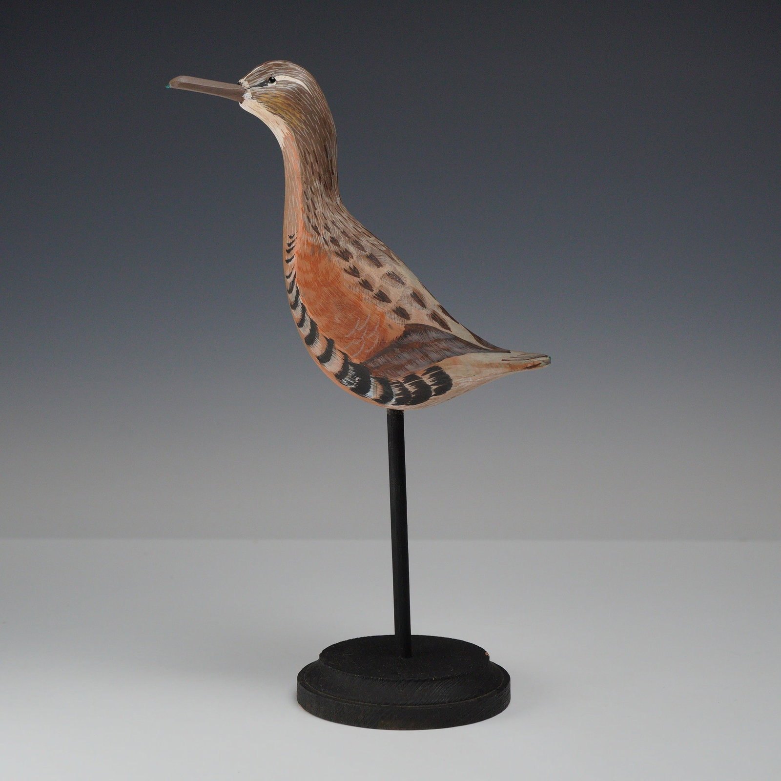Richard Glick for R&F Decoys Hand-Carved Shorebird Decoy: This hand-carved and hand-painted wooden shorebird decoy is a work by Richard Glick for R&F Decoys. The bird is designed with a long, straight bill and features plumage rendered in shades of rufous, b
