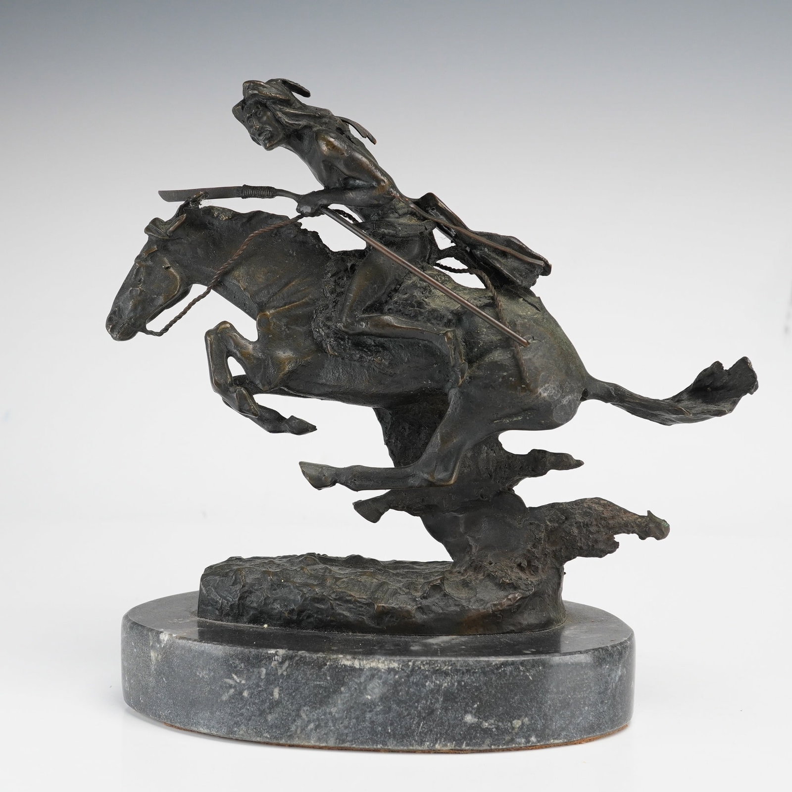 After Frederic Remington, The Cheyenne ASB Bronze Sculpture, Cast Signature: This cast bronze sculpture is titled The Cheyenne and is after Frederic Remington, as indicated by the style and the mark on the base. The piece depicts a Native American figure in a dynamic, forward-