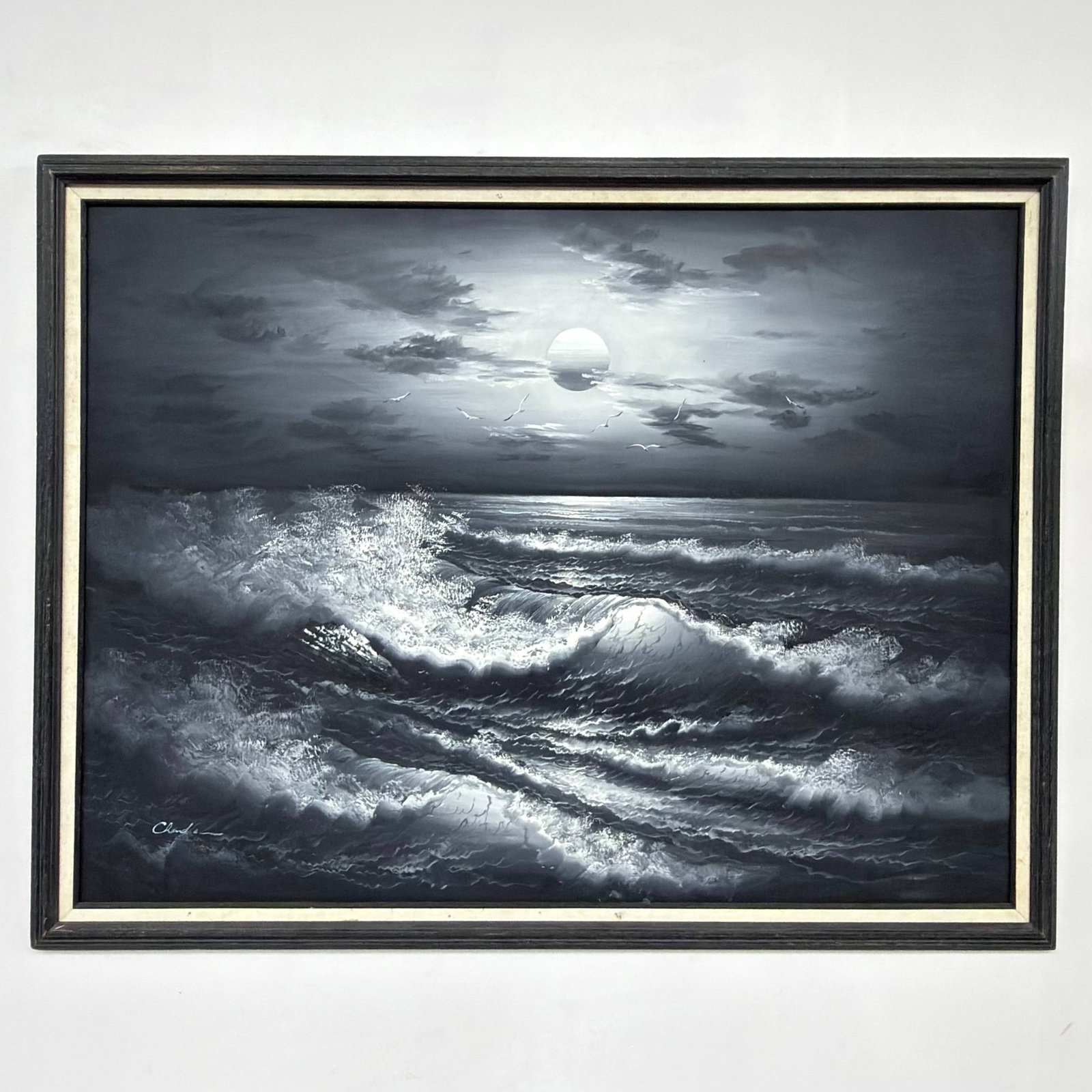 Chandler (20th Century), Monochromatic Ocean Seascape, Framed Oil on Canvas: This original oil on canvas painting depicts a dramatic, monochromatic nighttime seascape. The composition is centered around a bright, full moon breaking through a dark, clouded sky, casting a