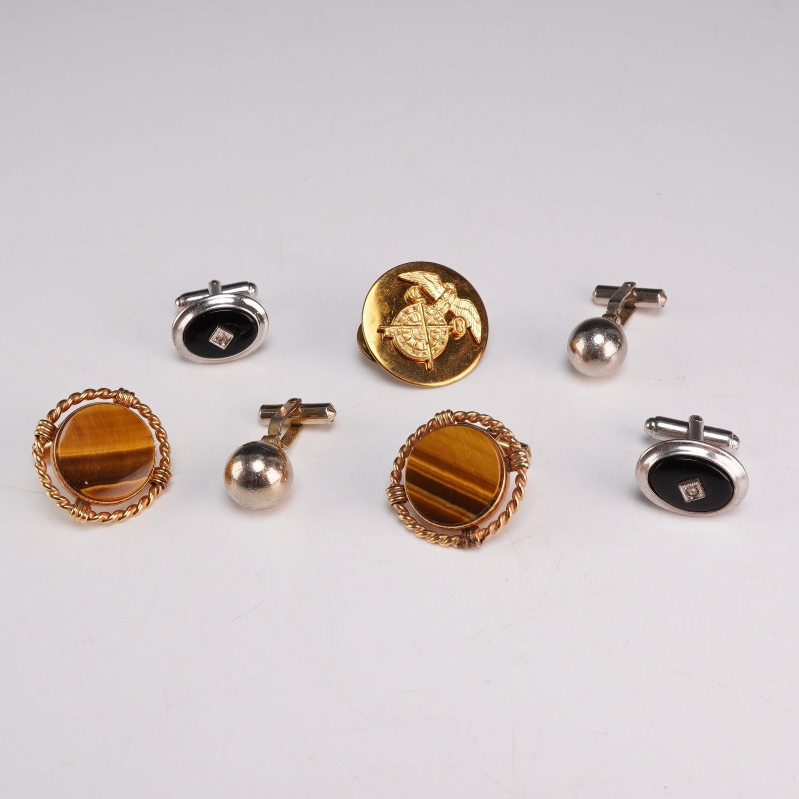 Jewelry Including 3 Pairs of Destino Cufflinks and a Gold-Tone Insignia Pin: This 7pc jewelry assortment includes three pairs of vintage cufflinks and a gold-tone insignia pin. All cufflinks feature toggles stamped with the maker mark DESTINO followed by a copyright symbol. On