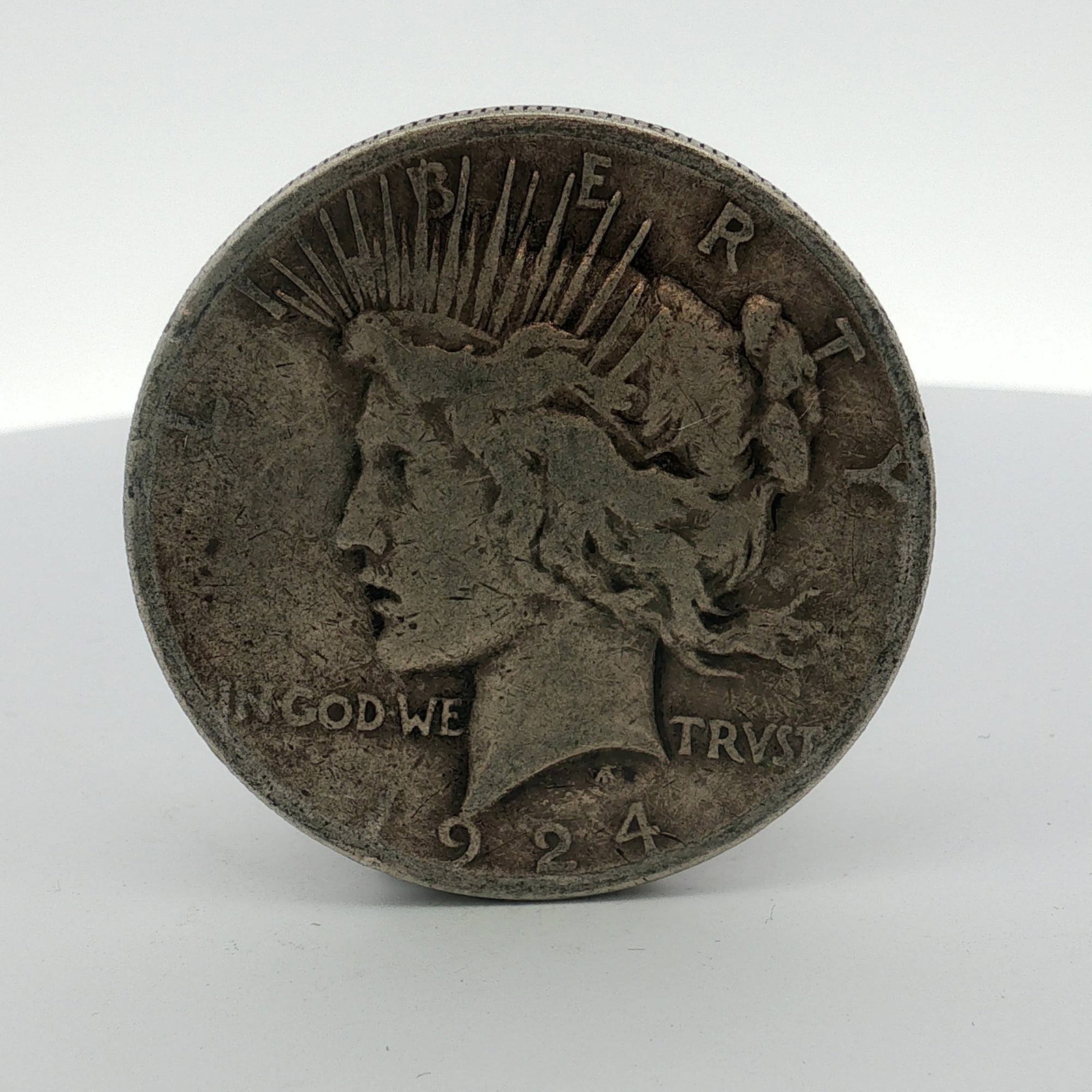 1924-S US Peace Silver Dollar: This US Peace silver dollar was struck at the San Francisco Mint in 1924. The coin is composed of 90 percent silver and 10 percent copper. The obverse features the Peace Dollar design with a
