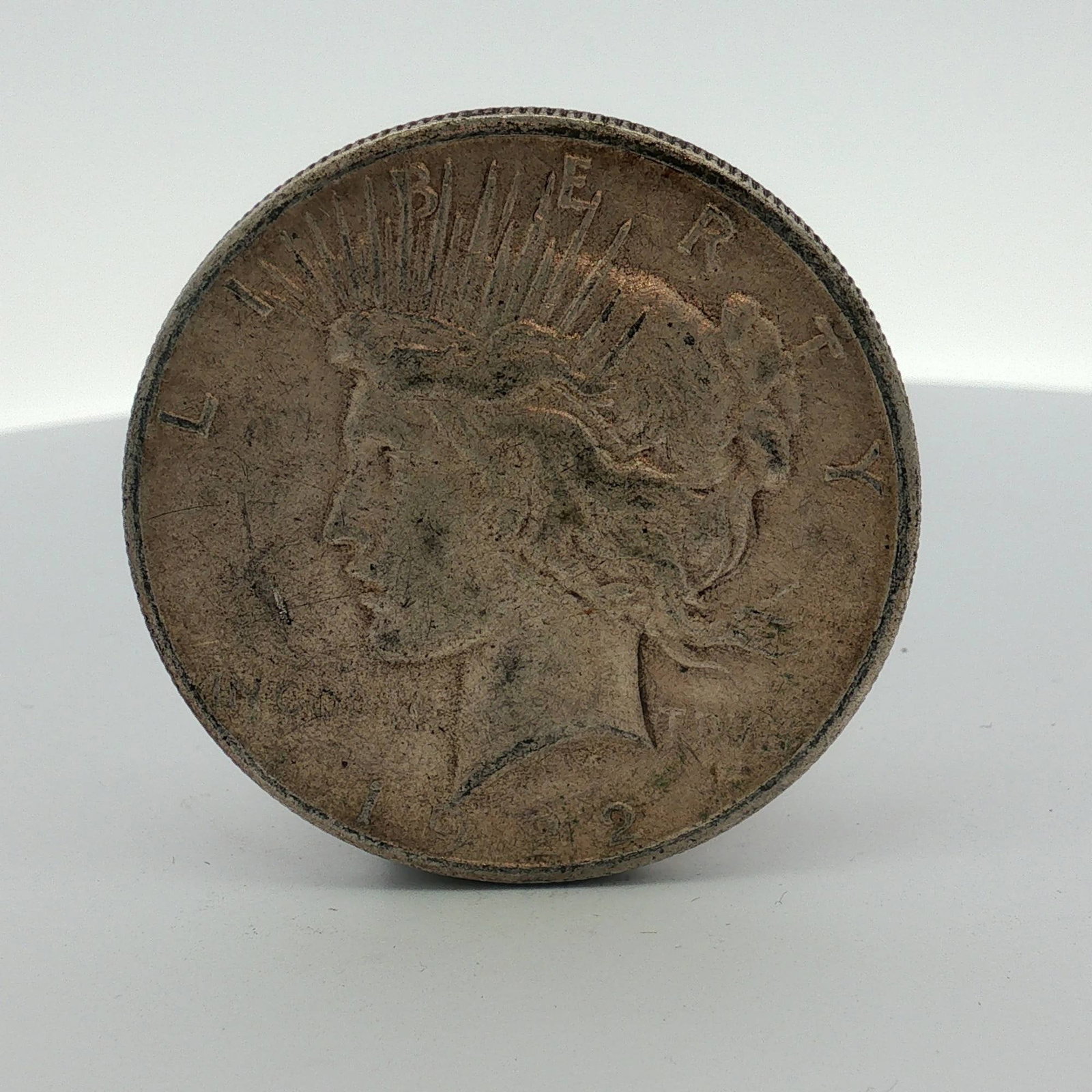 US 1922-S Peace Silver Dollar: US 1922-S Peace silver dollar minted at San Francisco. This specimen is struck in 90% silver and 10% copper. The obverse features the Peace Dollar design with the date 1922 and the inscription LIBERTY