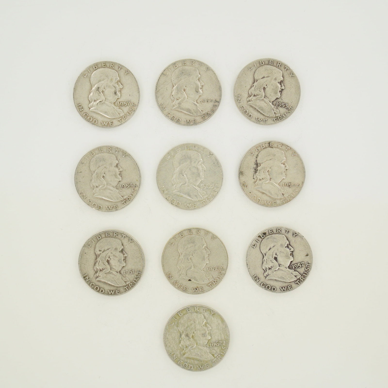 A Collection of Ten US Franklin Half Dollars 90 Percent Silver $5.00 Face Value: A collection of ten US Franklin Half Dollars struck in 90 percent silver. This group represents a $5.00 face value and includes the following date and mint mark combinations: one 1951, one 1953-D, two