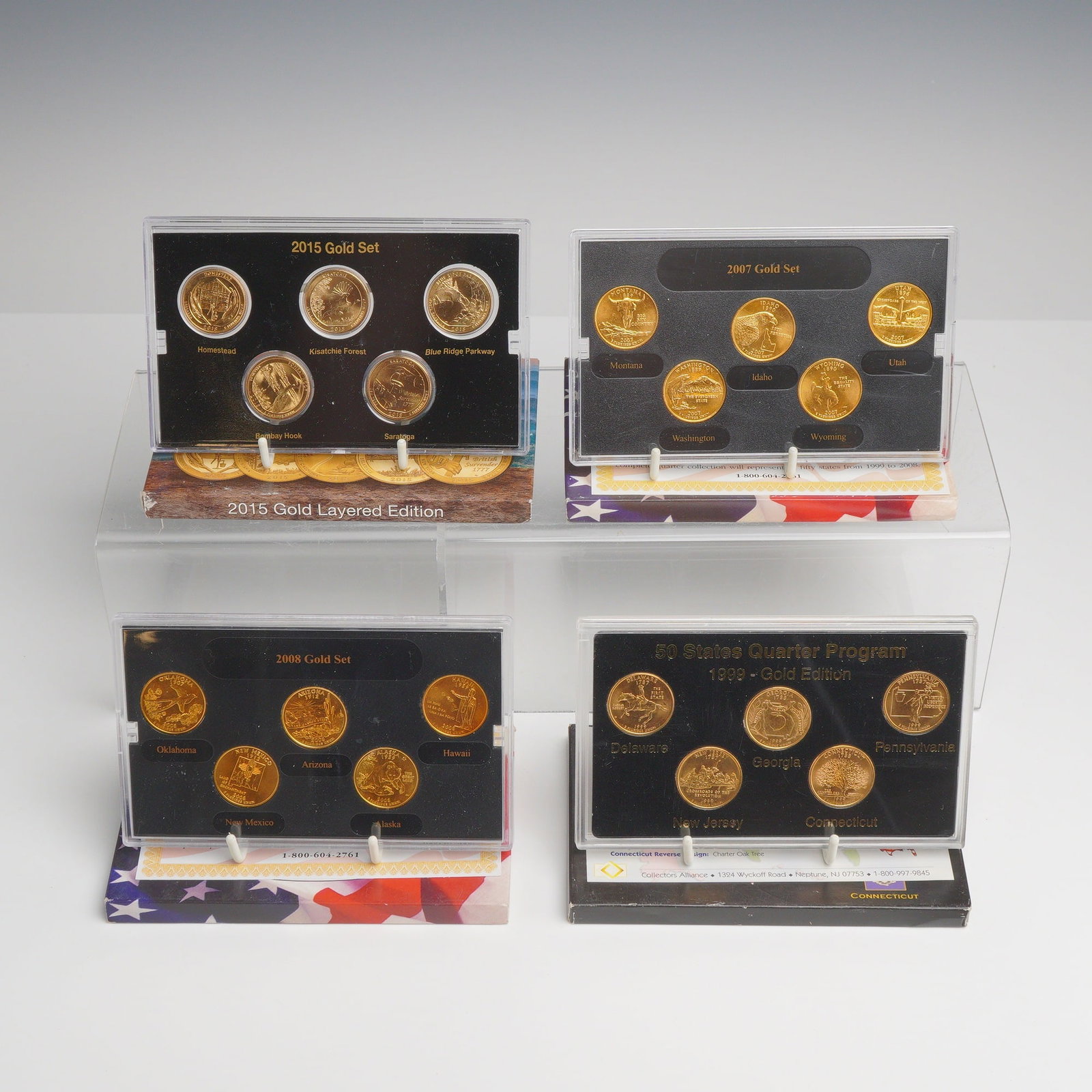 4pc US Quarter Sets with 24K Gold Plating: A collection of four sets of US Quarter Dollars featuring aftermarket 24 karat gold plating. The collection includes the 50 States Quarter Program 1999 Gold Edition, a 2007 Gold Set, a 2008 Gold Set, 