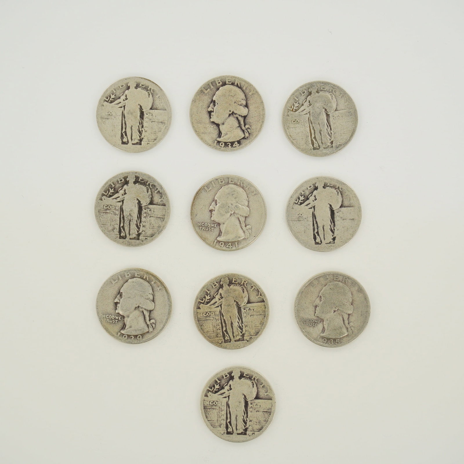 10pc U.S. 90% Silver Standing Liberty and Washington Quarters: This collection of US 90% silver quarters comprises a mixed date bag of both Standing Liberty and Washington types. The Washington quarters feature the Washington obverse with inscriptions LIBERTY and