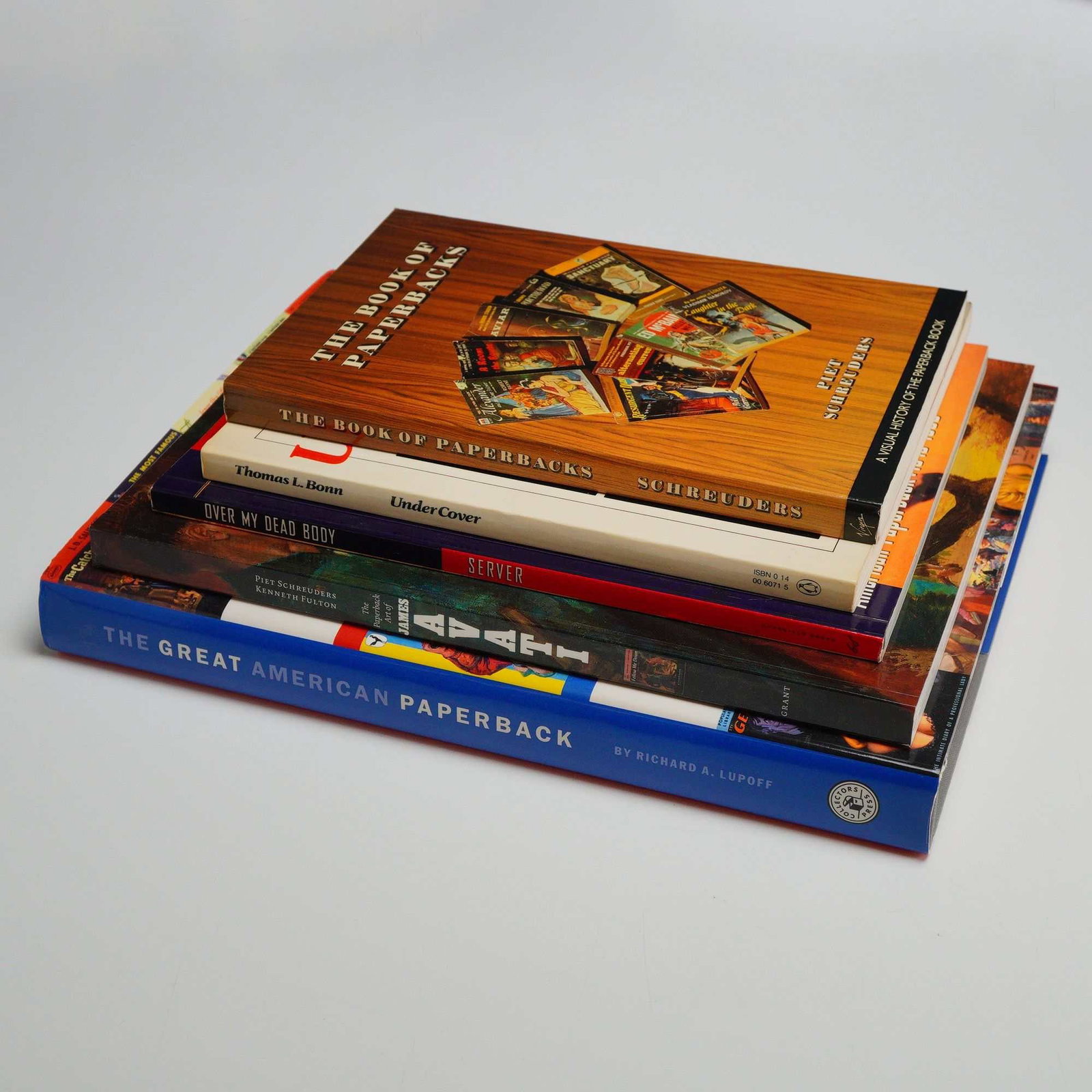 A Lot of 5 Books about Paperbacks. Various Publishers, 1981-2005. First Editions: This lot of 5 books about paperbacks offers a comprehensive visual history of mid-20th-century American mass-market fiction and cover art. The collection is led by The Great American Paperback: An