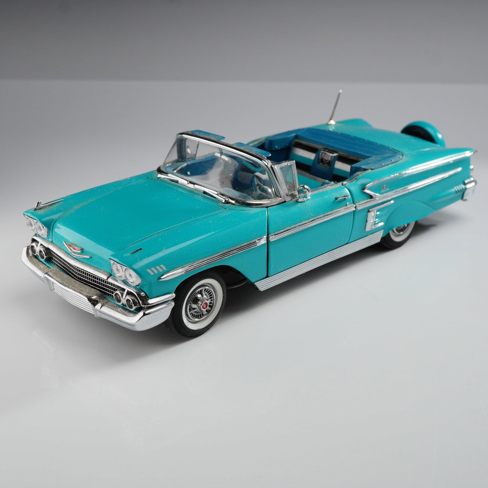 The Danbury Mint 1958 Chevrolet Impala Convertible Die-Cast Model Car: A 1:24 scale die-cast metal model of a 1958 Chevrolet Impala convertible, produced by The Danbury Mint as part of the Classic Cars Collection. The vehicle is finished in turquoise with a matching