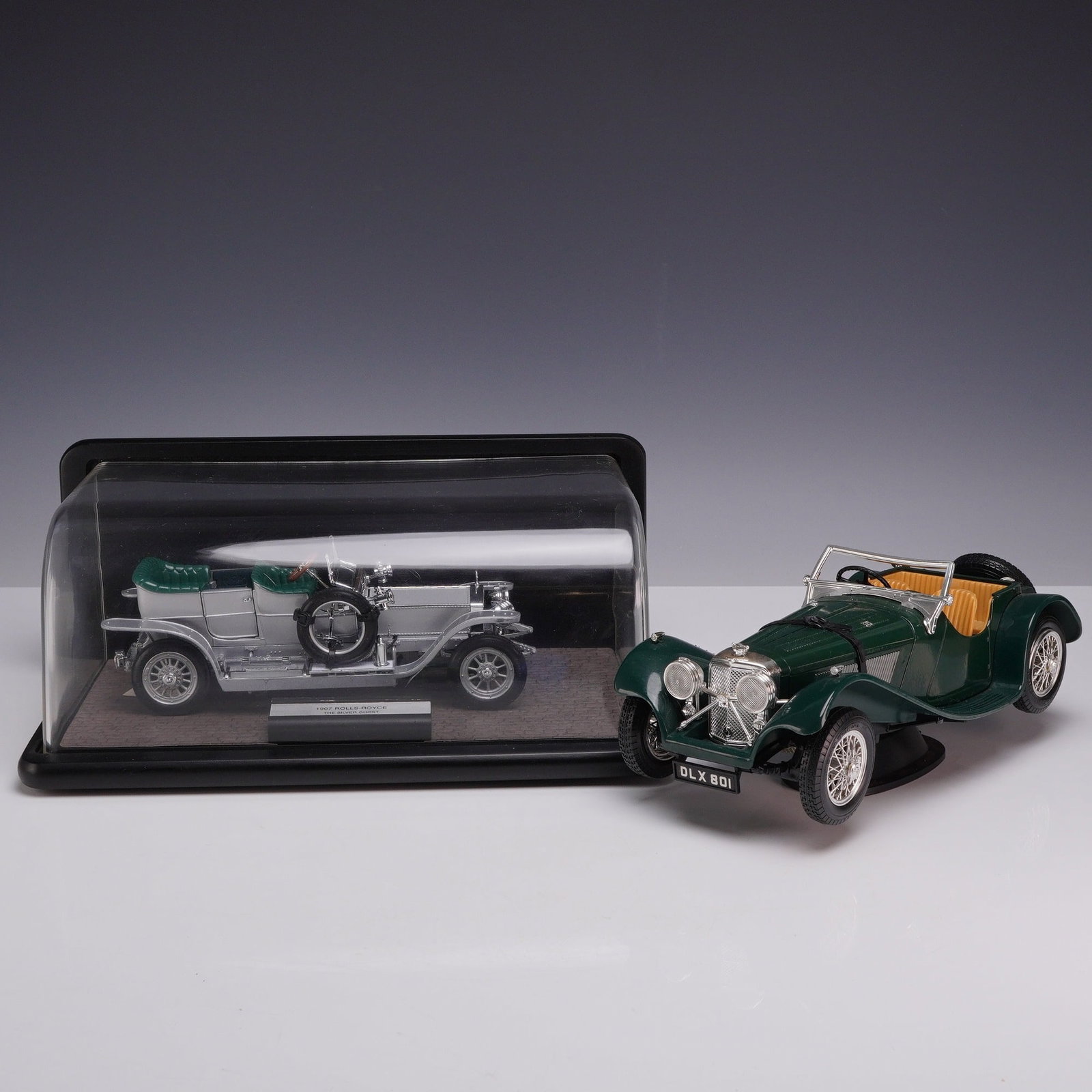Two Burago Italy 1937 Jaguar SS 100 and Franklin Mint 1907 Rolls-Royce Silver Ghost Model Cars: This lot features two die-cast model automobiles produced by different manufacturers. The first is a Franklin Mint Precision Models 1907 Rolls-Royce Silver Ghost, manufactured in 1986. The model is co