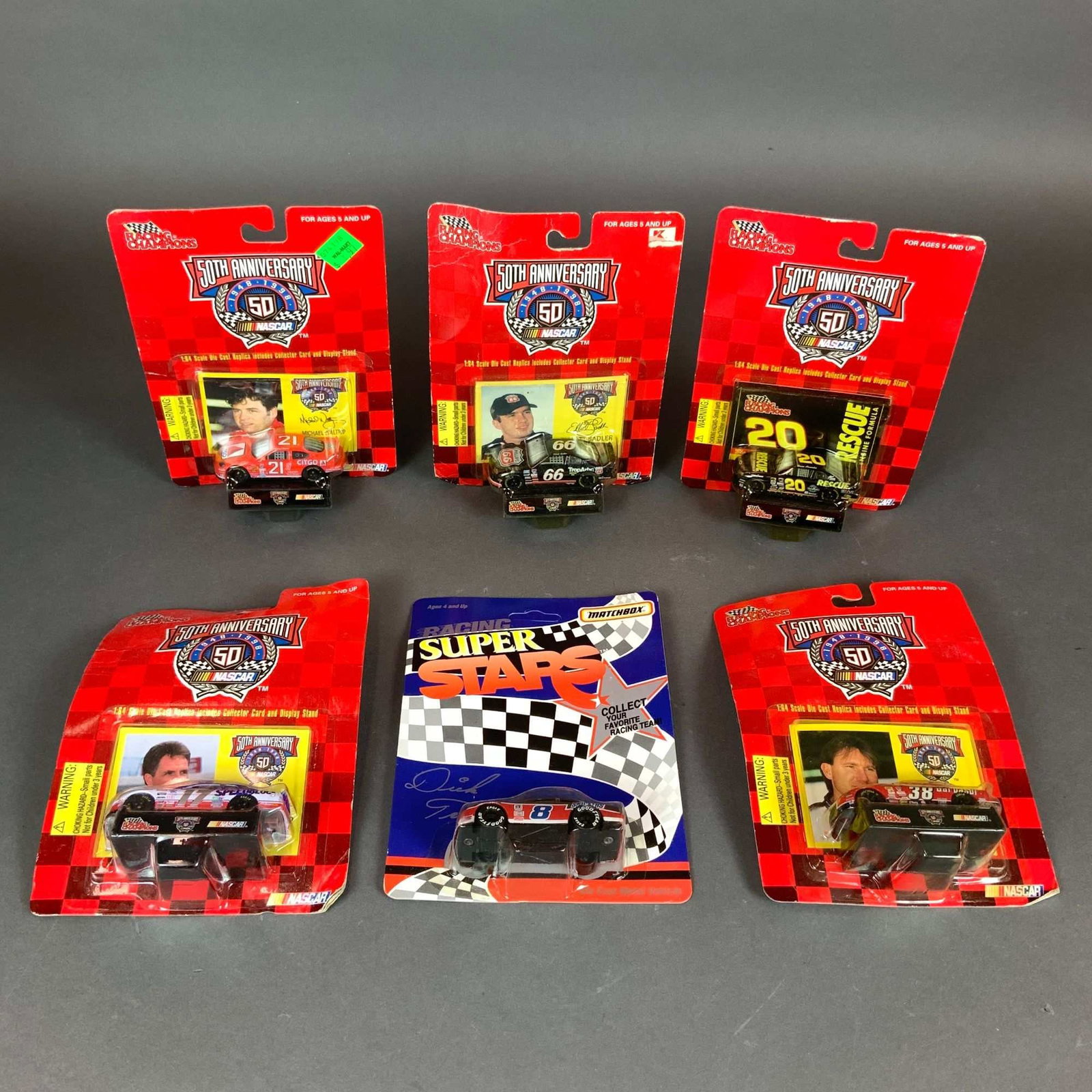 A Group of Six NASCAR 1:64 Scale Die-Cast Model Cars Including Racing Champions 50th Anniversary and: This lot comprises six factory-sealed 1:64 scale die-cast NASCAR model cars. Five items are from the Racing Champions 50th Anniversary series, produced to commemorate the years 1948 to 1998. Each of