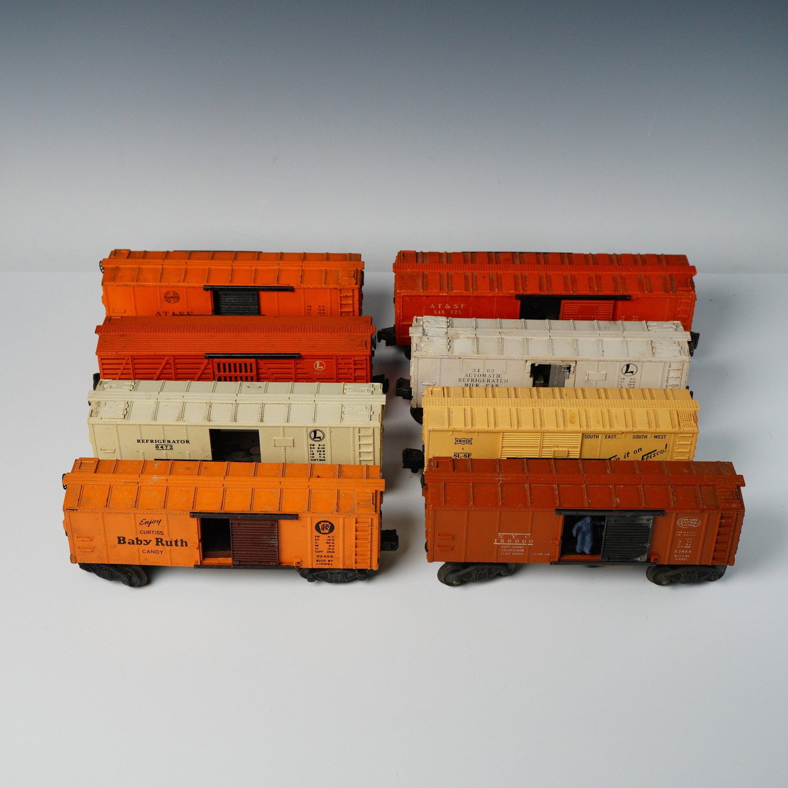 8pc Lionel O Gauge Post-War Freight Cars: A collection of eight O-gauge model railroad freight cars manufactured by The Lionel Corporation. Attribution based on visible markings and market consensus identifies these as Post-War production, ch