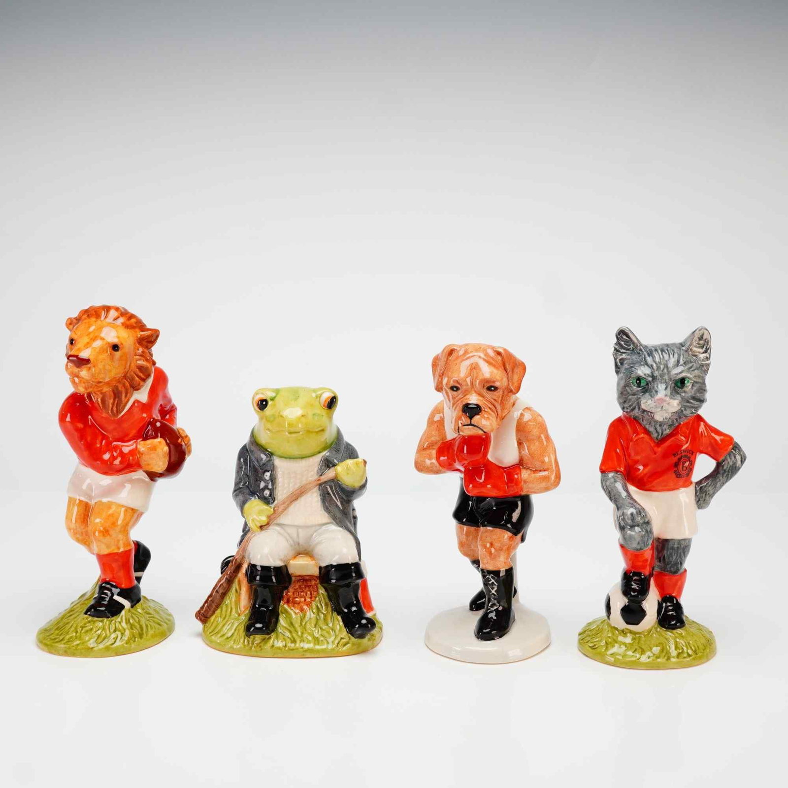 Beswick Sporting Character and Footballing Felines Figurines: This collection includes four Beswick glazed porcelain figurines produced for Sinclaire as part of the Sporting Character and Footballing Felines collections. The set features Last Lion of Defense,