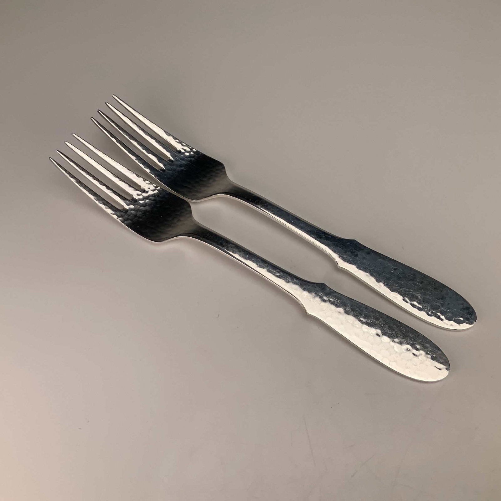 A Pair of Georg Jensen Mermaid Pattern Silverplate Forks: This lot consists of two silver-plated forks in the Mermaid pattern by Georg Jensen. These items are made of electroplated nickel silver (EPNS) and were produced in Denmark. The design is