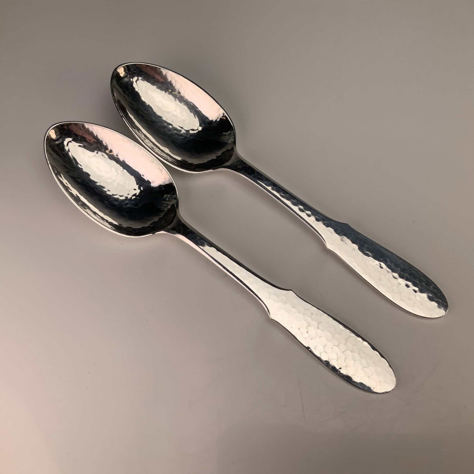 A Pair of Georg Jensen Mermaid Pattern Hammered Silverplate Place or Oval Soup Spoons: This pair of silver-plated spoons is in the Mermaid pattern by Georg Jensen of Denmark. Each spoon is constructed from electroplated nickel silver (EPNS) and features a distinctive hammered or