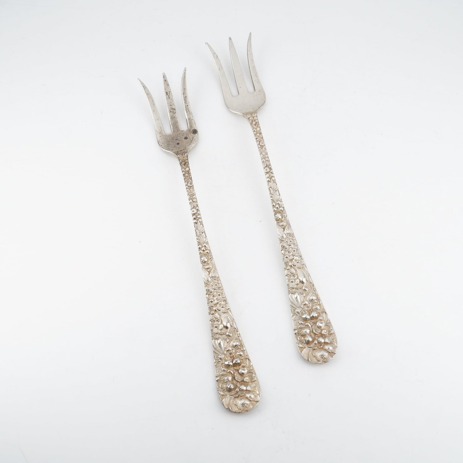 2pc Kirk Stieff Sterling Silver Cocktail Forks, Stieff Rose: Elegant pair of cocktail forks featuring the iconic Stieff Rose design, originally introduced in 1892. Each fork displays a finely detailed sterling silver handle with elaborate floral repousse