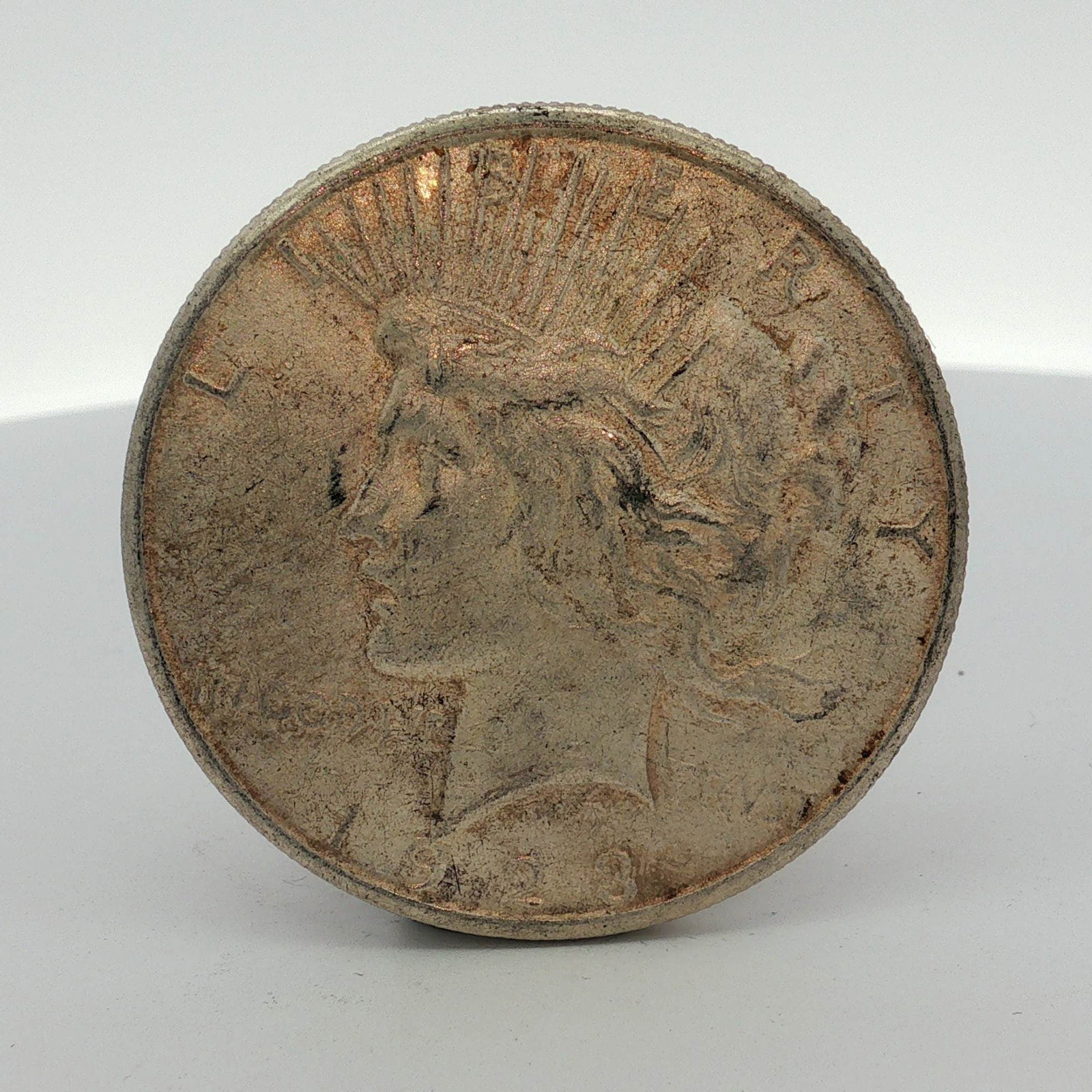 1923-S US One Dollar Peace Silver Dollar Coin, Circulated: A US Peace silver dollar dated 1923-S, was struck at the San Francisco Mint with the S mint mark visible on the reverse. This coin is composed of 90% silver and 10% copper and features the standard