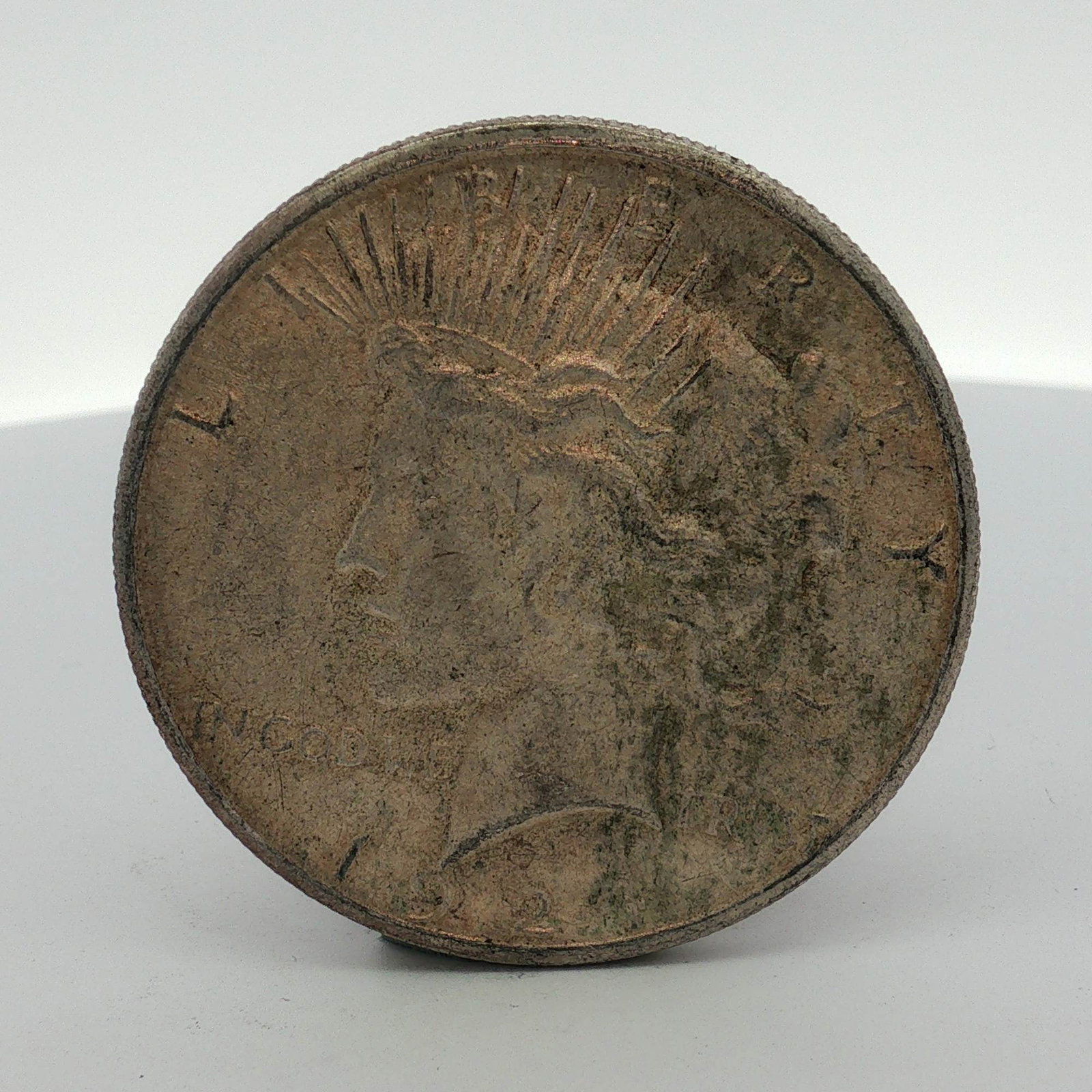 1924-S US One Dollar Peace Silver Dollar Coin, Circulated: This 1924-S US Peace silver dollar was struck at the San Francisco Mint. The coin is composed of 90 percent silver and 10 percent copper, containing approximately 0.7734 troy ounces of silver. It feat