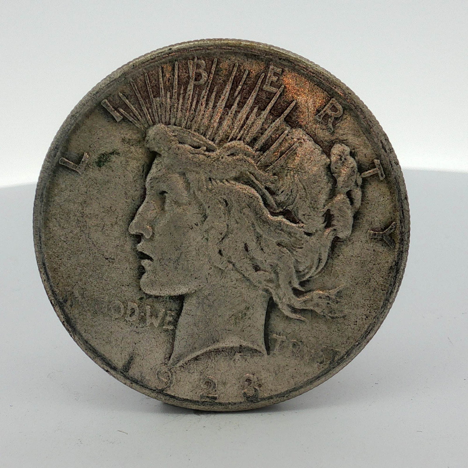 US 1923-S Peace Silver Dollar: This US 1923-S Peace silver dollar is a circulated specimen struck at the San Francisco Mint. Composed of 90% silver and 10% copper, this Peace dollar features the standard design elements including t