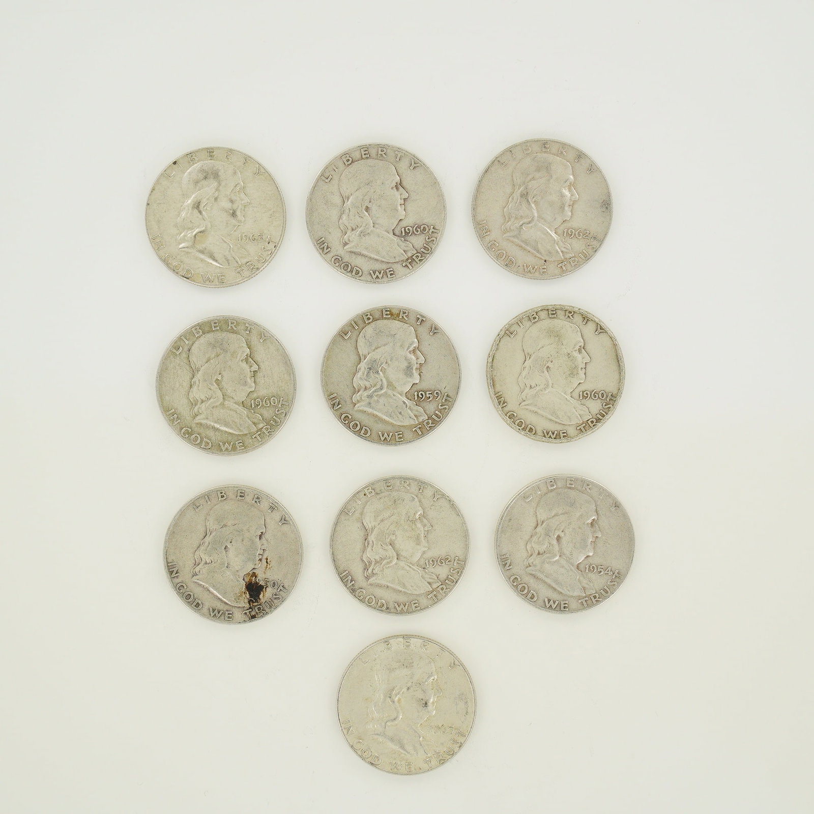 A Collection of US 90% Silver Franklin Half Dollars, $5.00 Face Value: A collection of US Franklin Half Dollars struck in 90% silver with a total $5.00 face value. The group includes various dates and mint marks including 1950, 1954-D, 1959-D, 1960-D, 1962-D, and 1963.