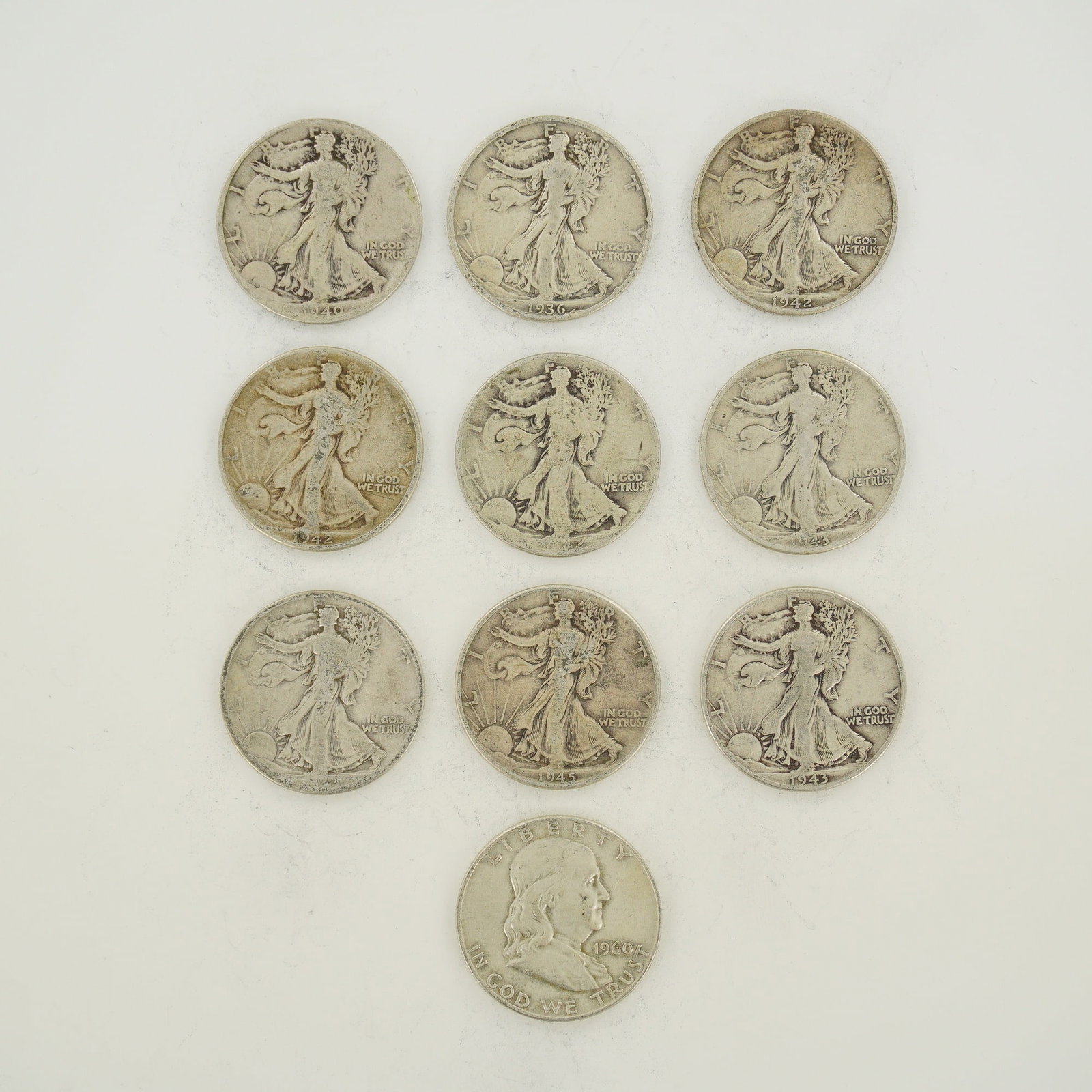 A Collection of US 90% Silver Walking Liberty and Franklin Half Dollars: This collection of US 90% silver coinage is offered as a mixed date bag of half dollars. The group includes Walking Liberty half dollars and a Franklin half dollar. Visible dates on the Walking