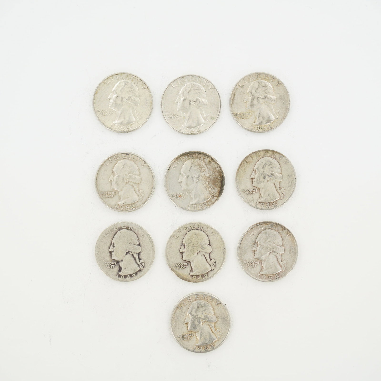 10pc Pre-1964 U.S. 90% Silver Washington Quarters: A collection of ten US Washington quarters composed of 90% silver and 10% copper. The lot includes coins with the following dates: 1942, 1943, 1944, 1954, 1962 (two), 1963, and 1964 (three). The