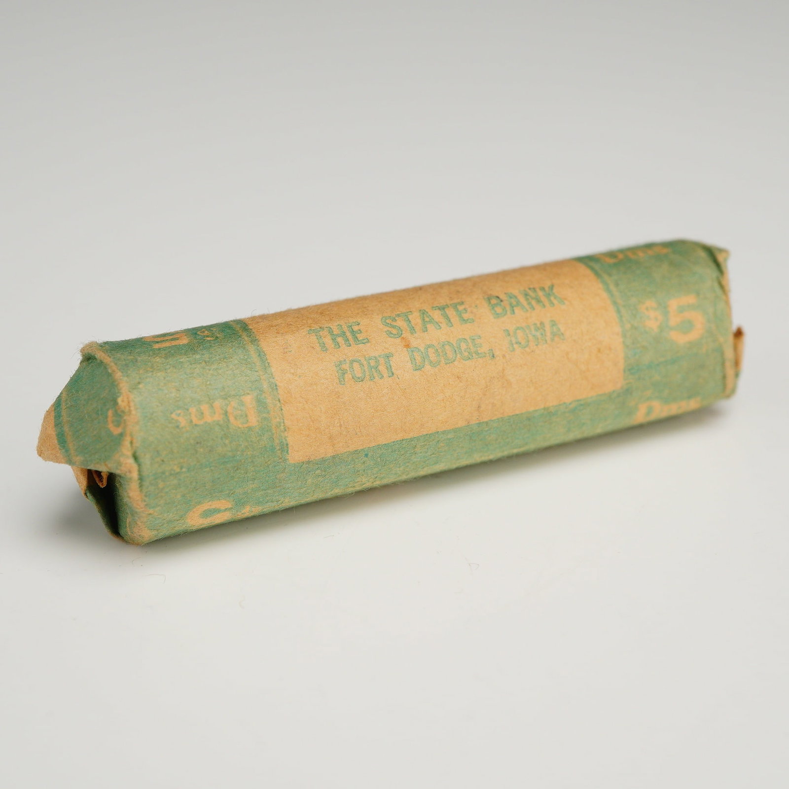 1 Roll of US $5.00 Bank Roll of 50 Mixed Date Dimes: This lot consists of an original bank-wrapped mixed date roll of 50 US dimes with a total face value of $5.00. The coins are contained within a vintage paper wrapper manufactured by the Spurgin