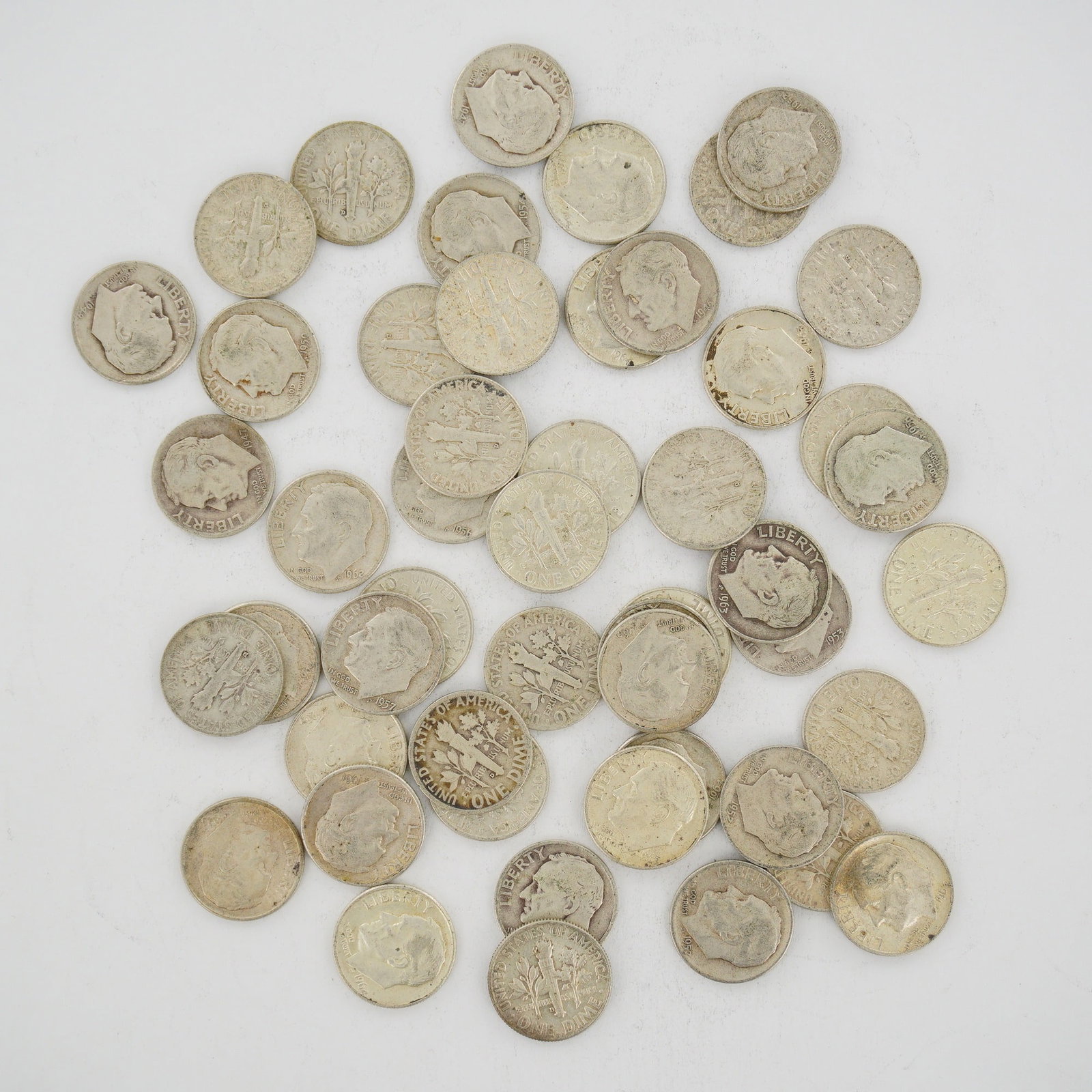 A Mixed Date Bag of US 90% Silver Roosevelt Dimes: A mixed date bag of US Roosevelt dimes struck in 90 percent silver alloy. This collection consists of multiple coins issued prior to 1965, featuring the Roosevelt obverse and the torch reverse design.