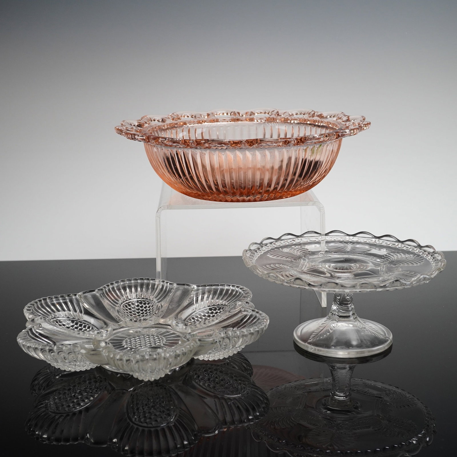 3pc US Glass and Anchor Hocking Bowl and Cake Stand: The lot includes an Anchor Hocking Old Colony Pink Open Lace bowl, a U.S. Glass Co. Missouri cake stand, and an egg holder dish. The centerpiece is the large circular bowl, executed in pink pressed
