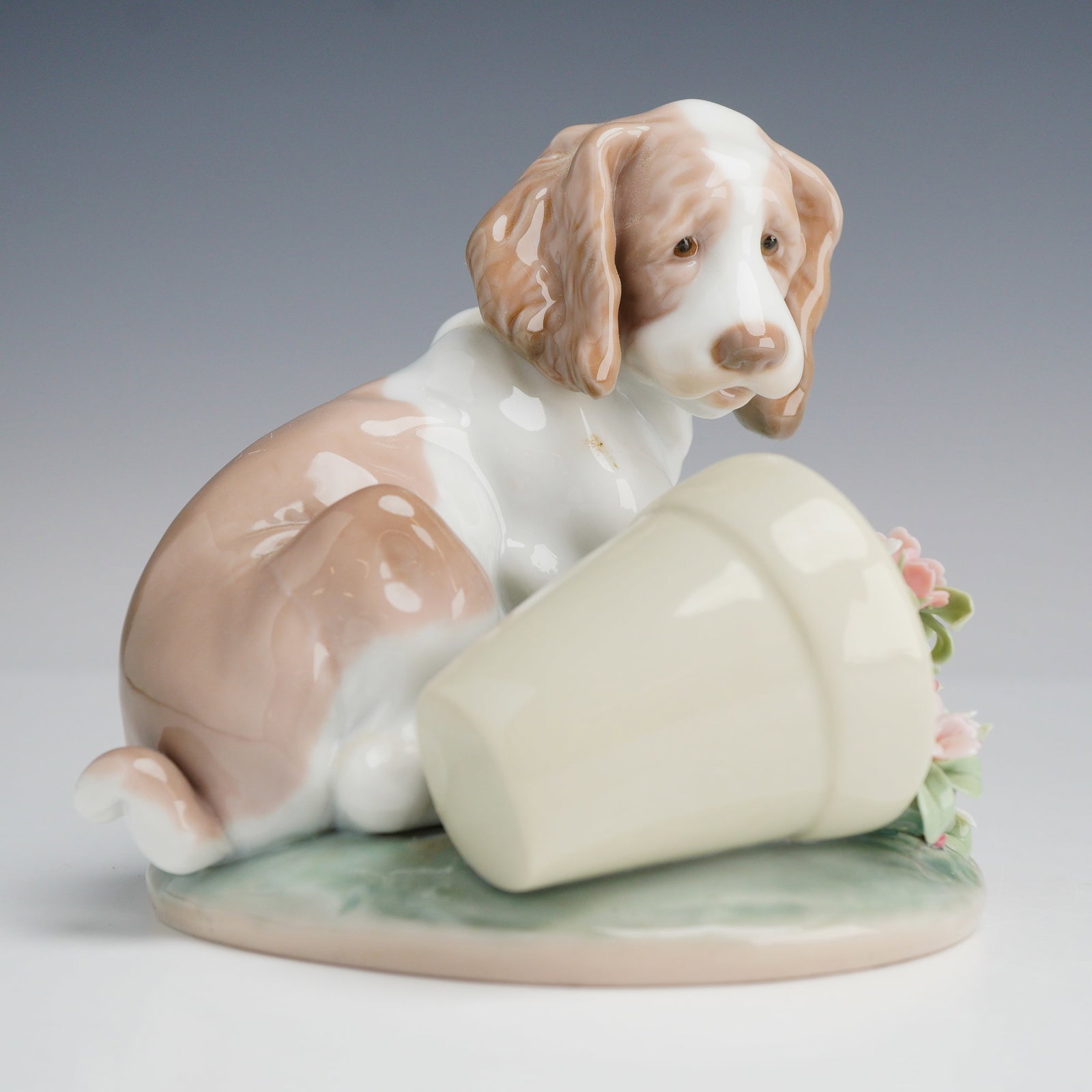 Lladro Porcelain Figurine It Wasnt Me 01007672: Lladro glazed porcelain figurine, model number 7672, titled It Wasnt Me. This piece features a spaniel-style puppy with white and tan patches, depicted in a sitting pose with a downcast expression nex