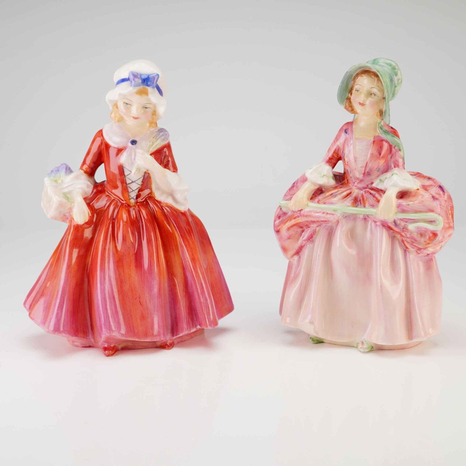 Royal Doulton Figurines, Bo Peep and Lavinia: A pair of Royal Doulton fine bone china figurines featuring the subjects Bo Peep and Lavinia HN1955. The Lavinia figurine, model HN 1955, depicts a young woman in 18th-century style attire with a vibr