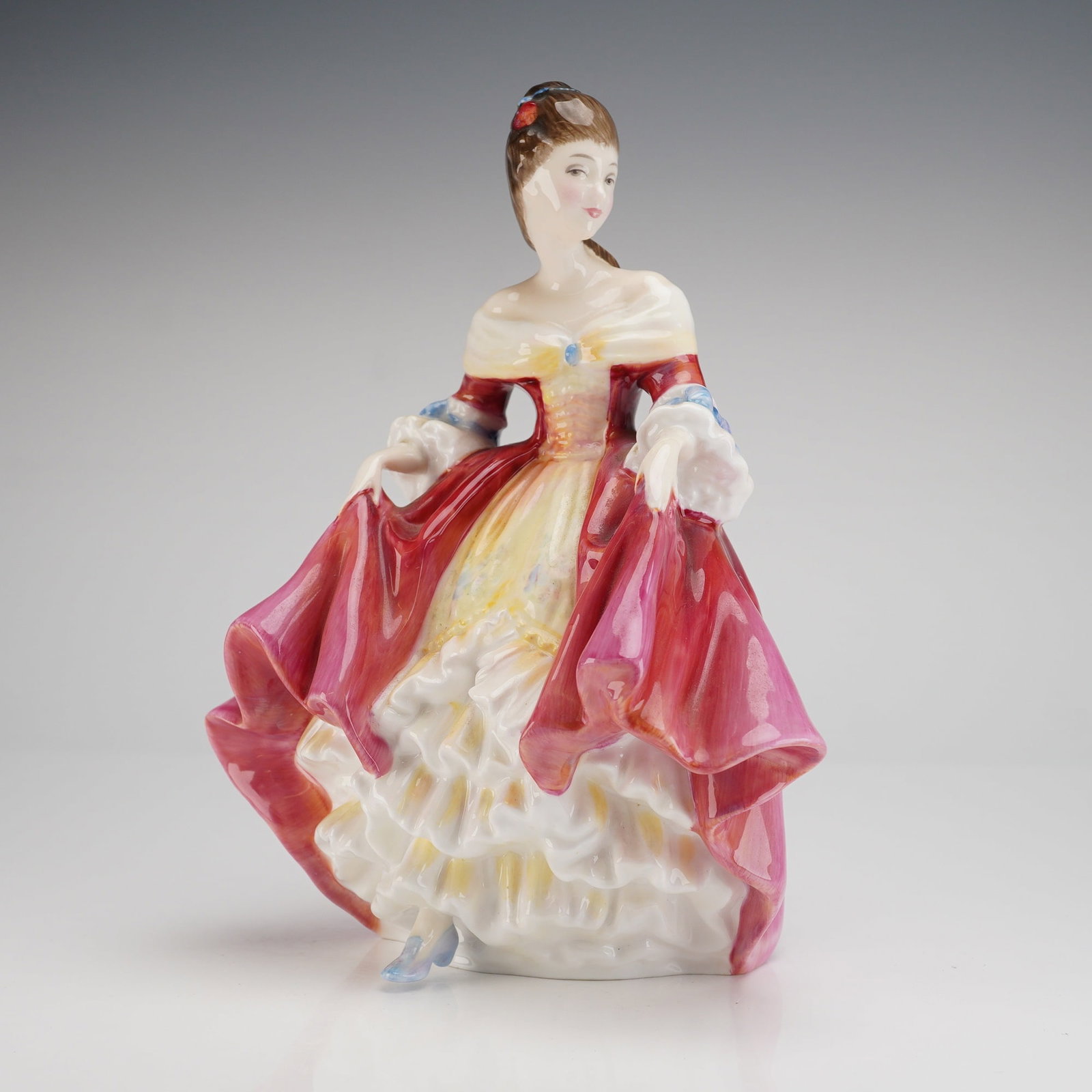 Royal Doulton Southern Belle HN2229 Porcelain Figurine: A single glazed porcelain figurine manufactured by Royal Doulton, identified by the base marking and web consensus as the model "Southern Belle," HN2229. The figure depicts a woman in a dynamic pose, 