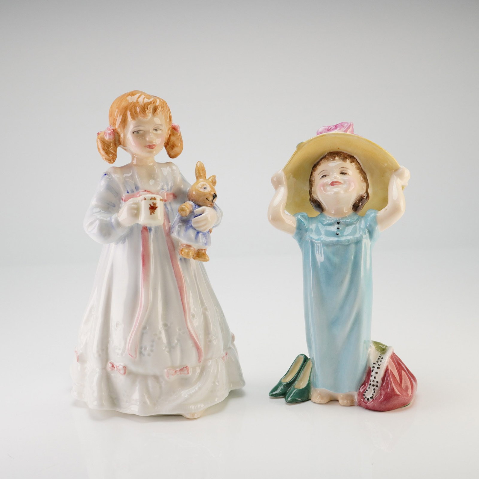 Royal Doulton Porcelain Figurines, A Pair of Bunny's Bedtime and Make Believe: This pair of Royal Doulton glazed porcelain figurines includes Bunny's Bedtime and Make Believe. Bunny's Bedtime, model HN 3370, was modeled by Nada M. Pedley and issued in 1991 as a limited edition e