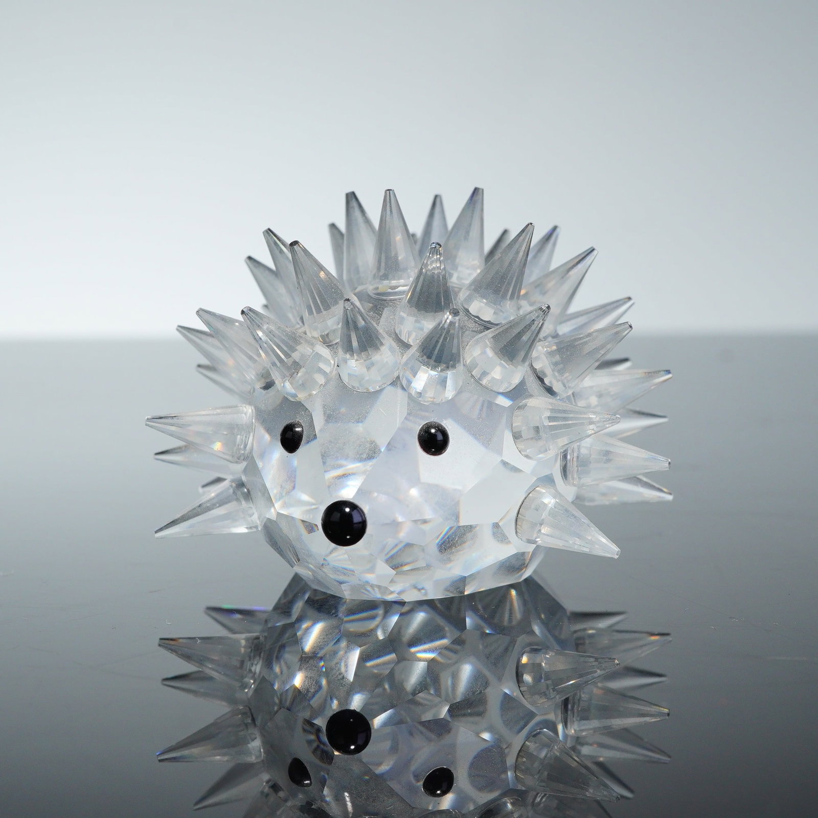 Swarovski Crystal Figurine Hedgehog Porcupine: A Swarovski Crystal Figurine depicting a hedgehog, also commonly identified as a porcupine. The piece is crafted from faceted lead crystal with a rounded body and numerous pointed crystal quills.
